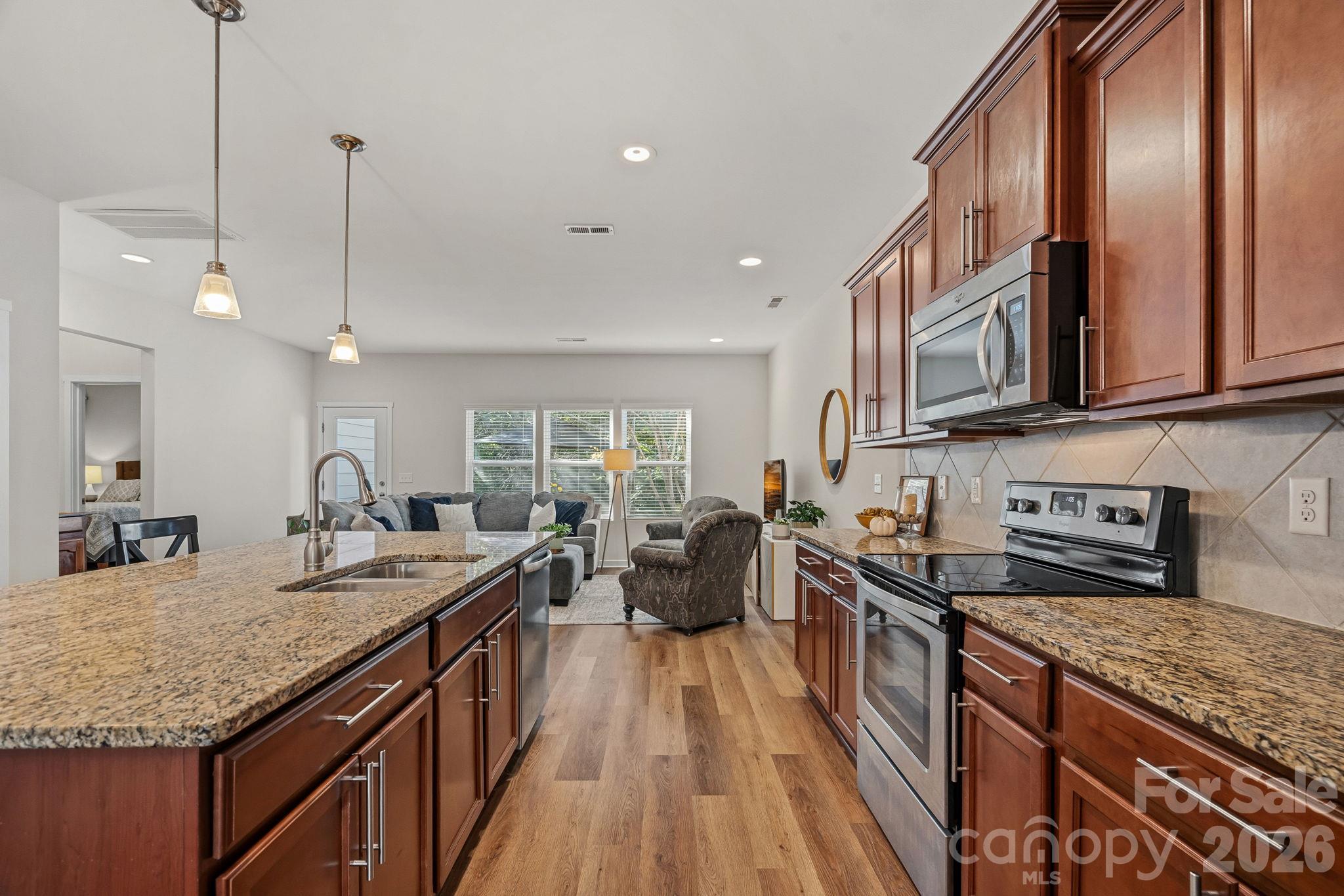 Granite counters and handsome wood cabinets - 13326 Pierre Reverdy Drive, Davidson