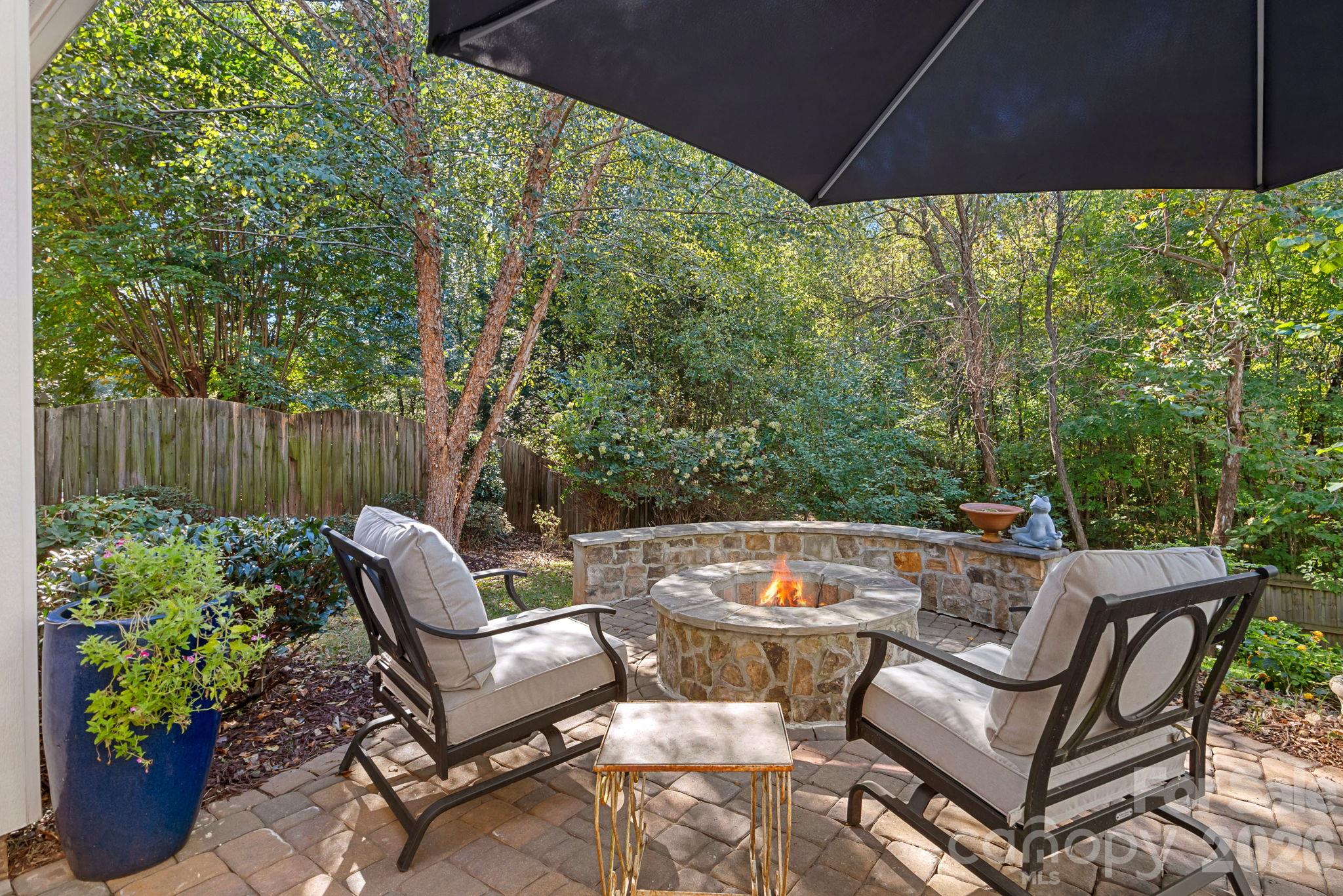 Patio with Firepit overlooking private backyard - 13326 Pierre Reverdy Drive, Davidson