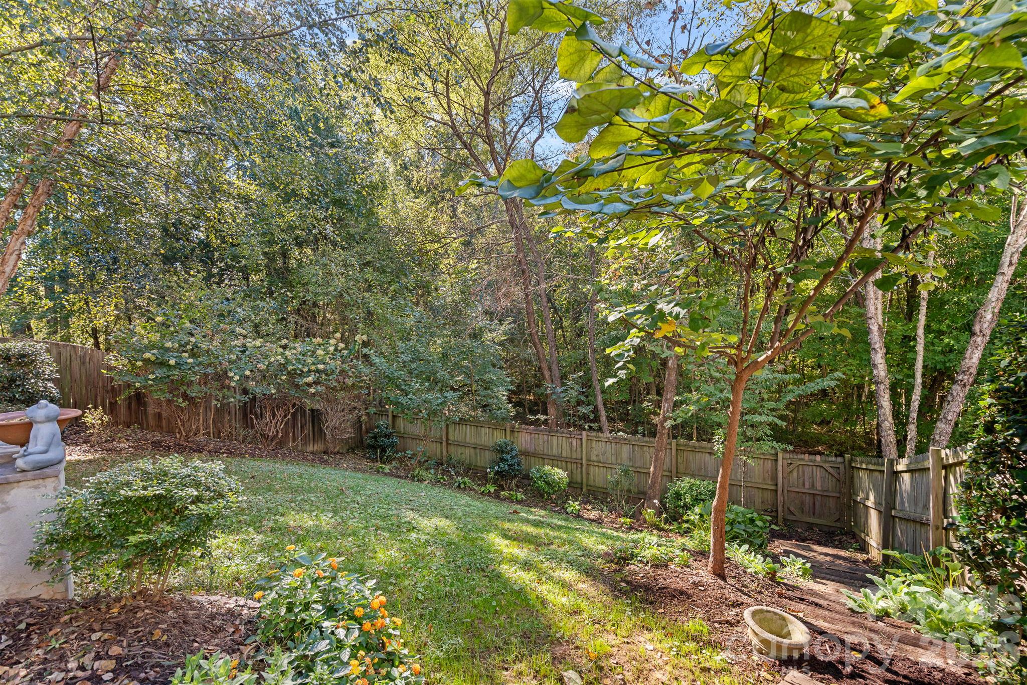 Fully fenced backyard with mature landscape - 13326 Pierre Reverdy Drive, Davidson