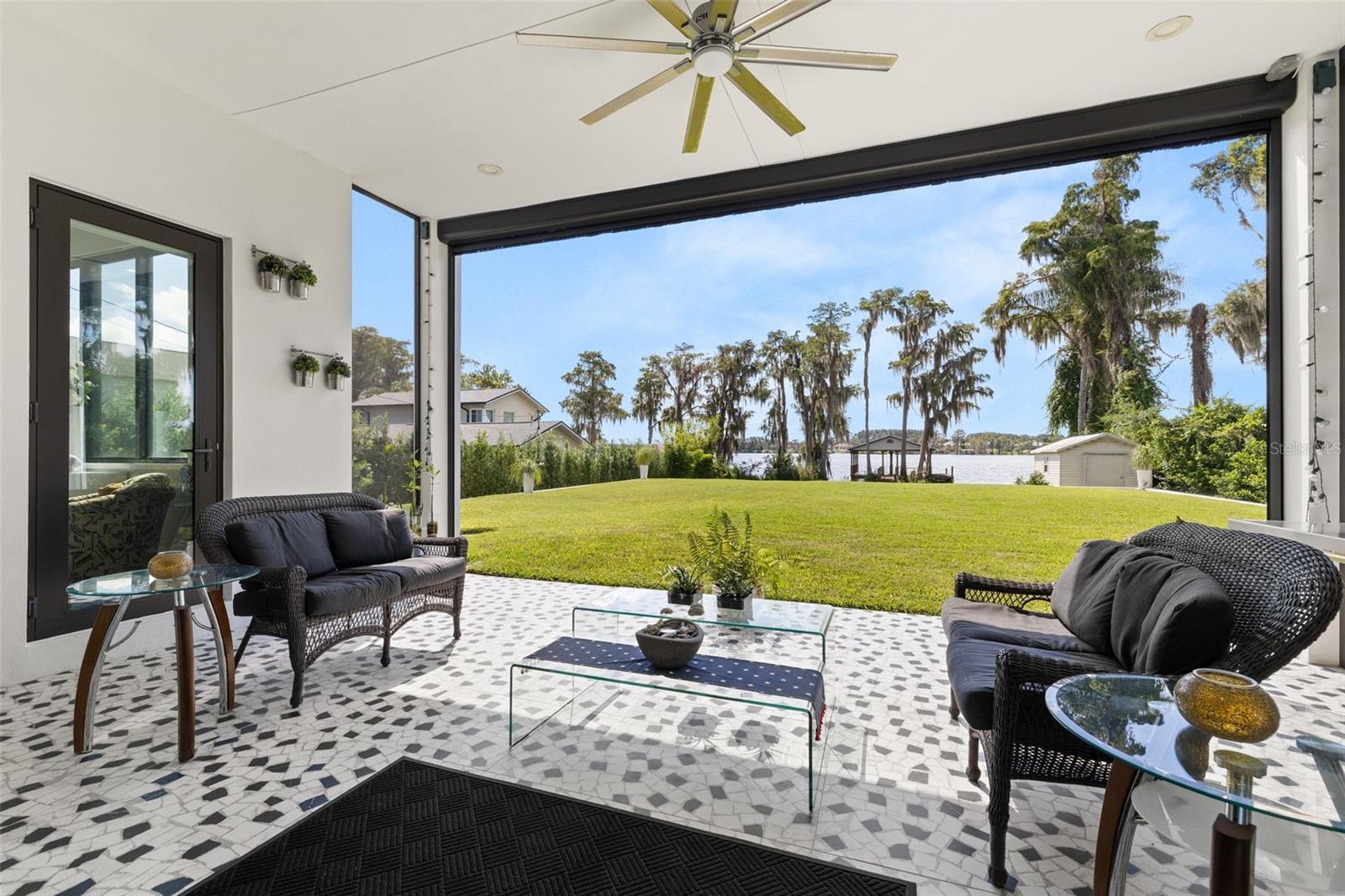 Outdoor patio with motorized shutters - 12620 S LAKE SAWYER LN, WINDERMERE