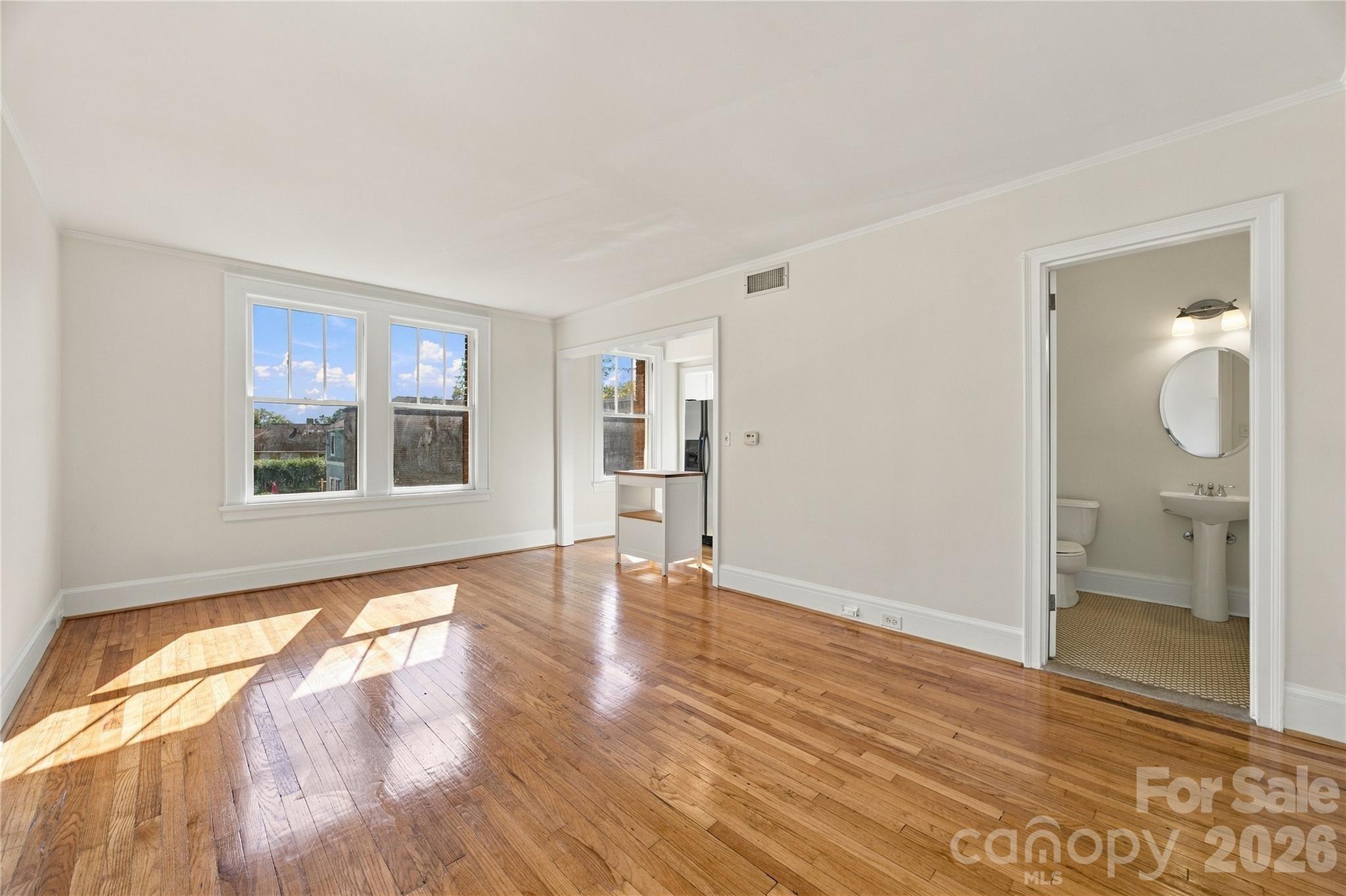 Spacious living room with room for a cozy dining area. - 712 Louise Avenue, Charlotte