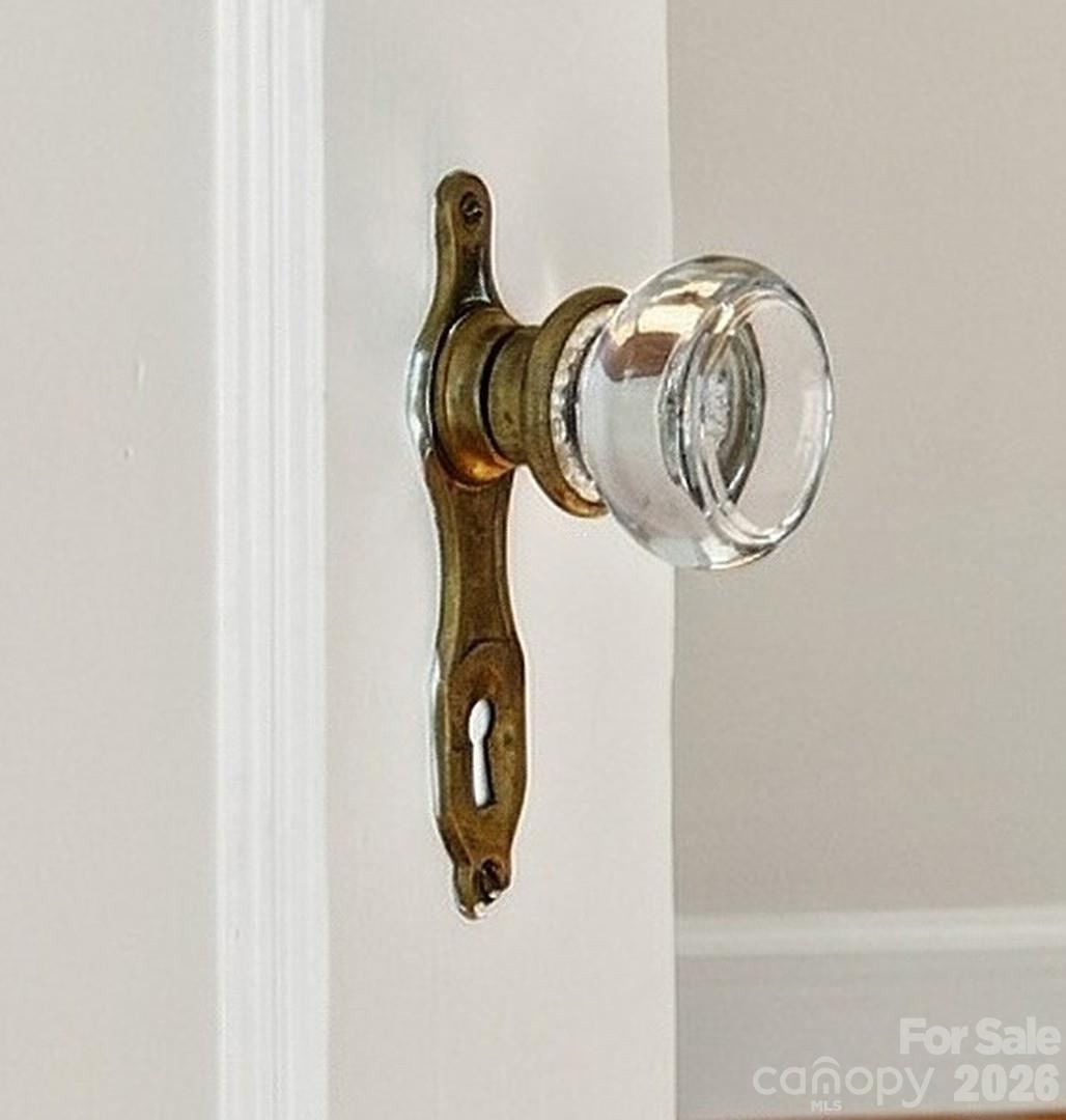 Crystal doorknobs - a little sparkle among the charming details found throughout. - 712 Louise Avenue, Charlotte