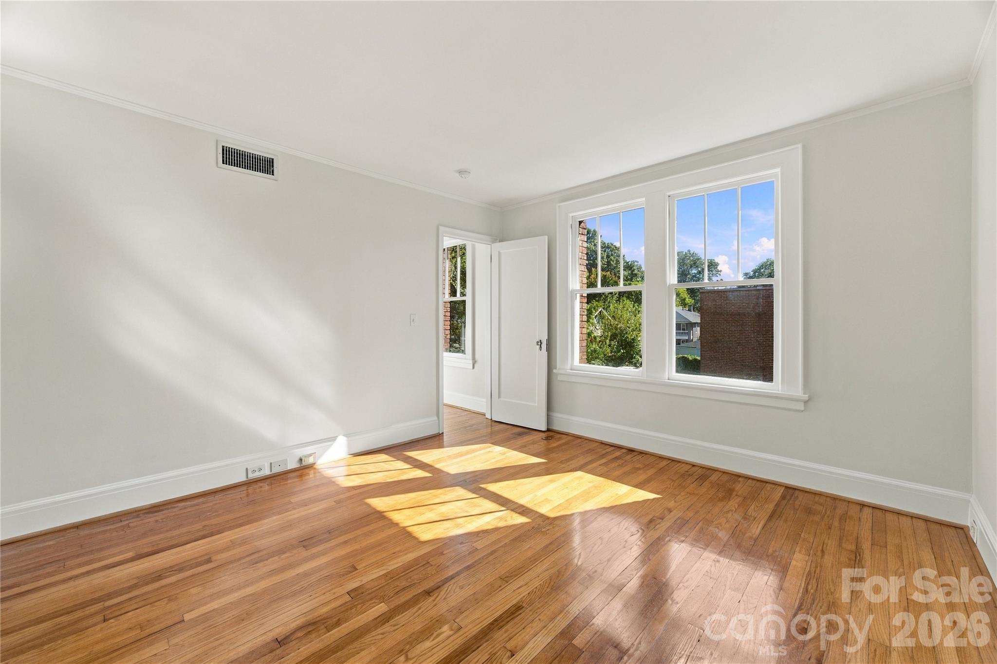 Primary bedroom - Bring the king bed! Space for your bedroom furniture, a generous walk-in closet, and an en suite bath. - 712 Louise Avenue, Charlotte