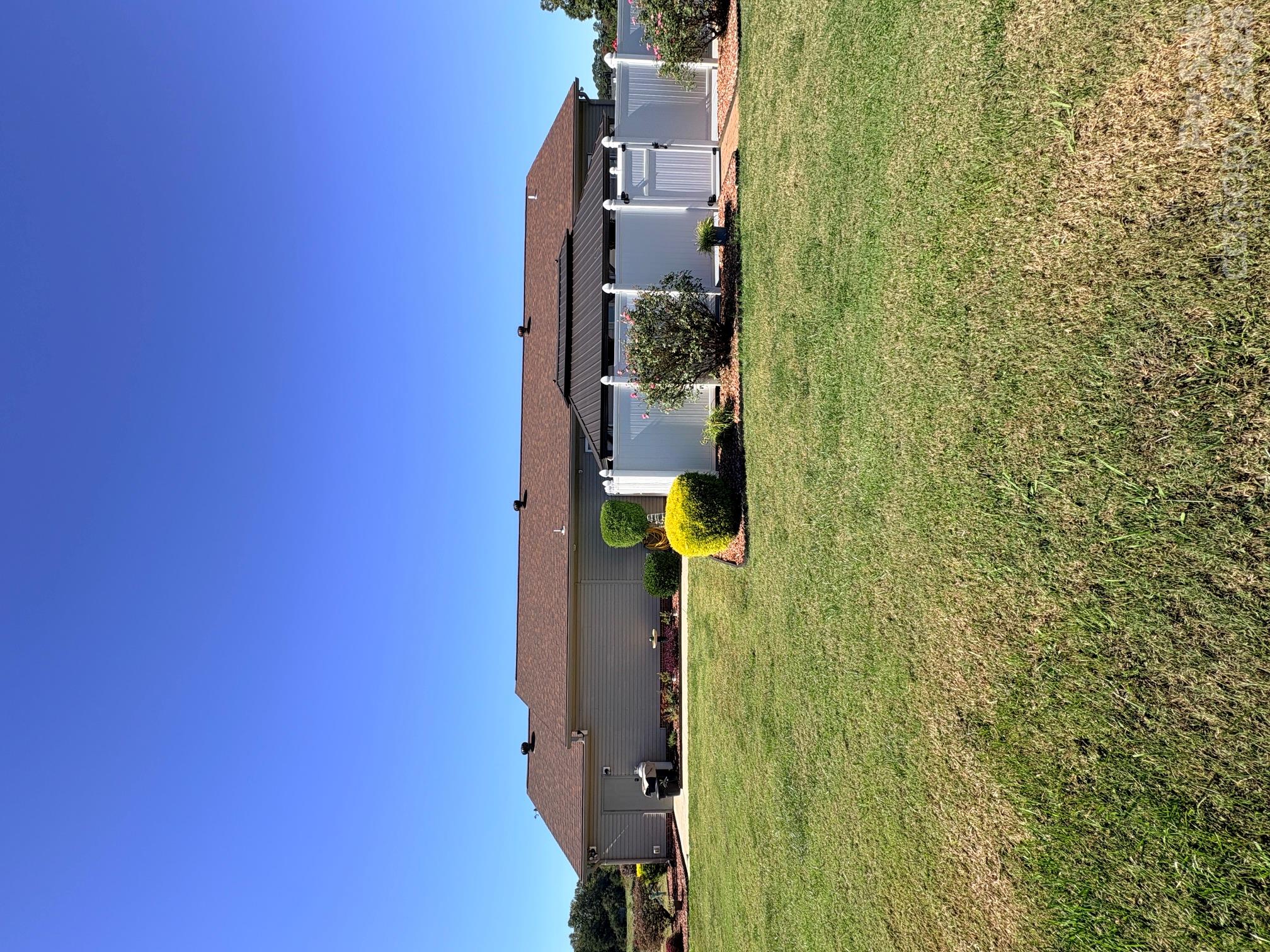Rear of home showing fenced rear Patio and walk through door into attached garage. - 643 Shoal Road, Lincolnton