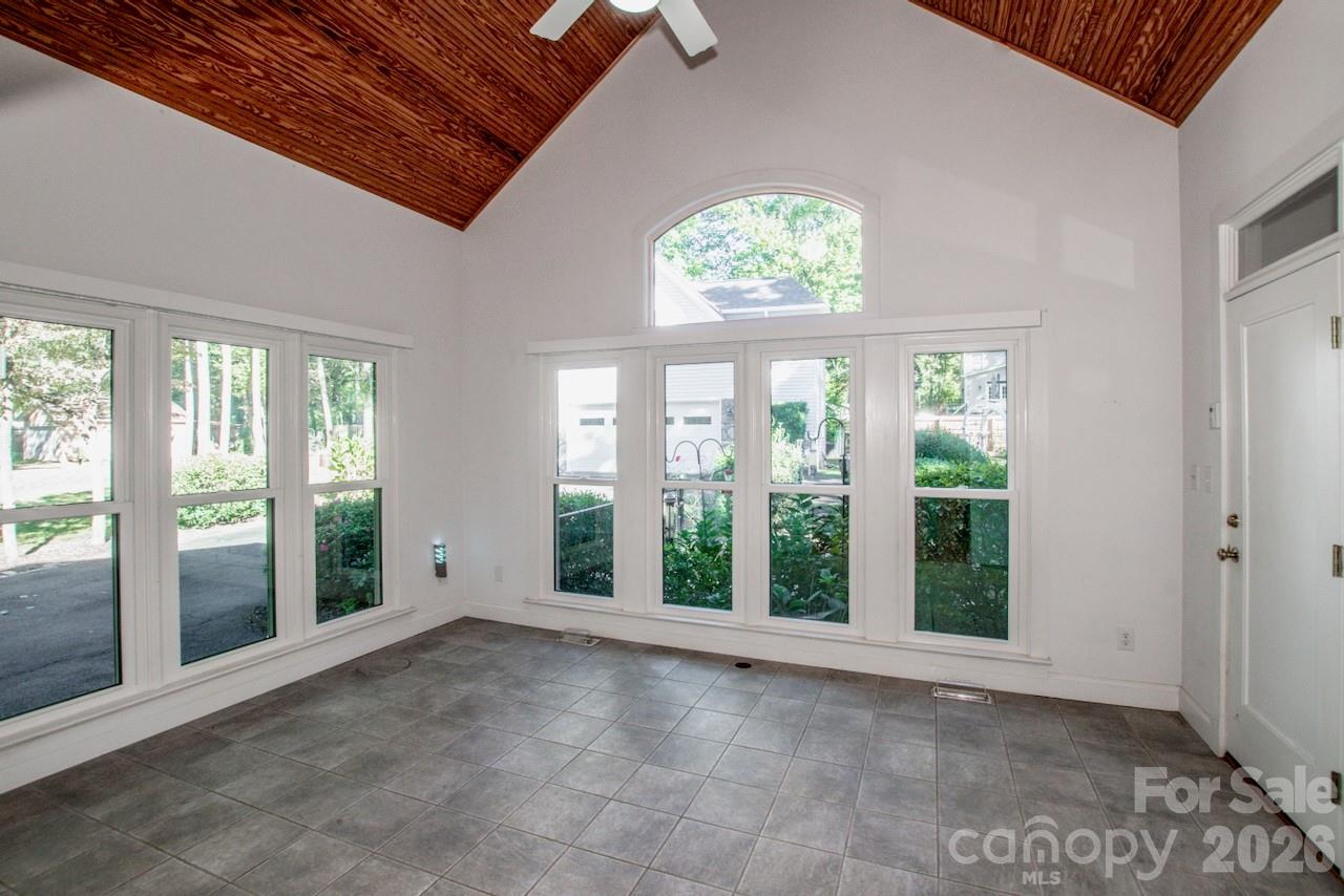 Sunroom with vaulted ceiling, tons of natural light and tile flooring - 351 Catalina Drive, Mooresville