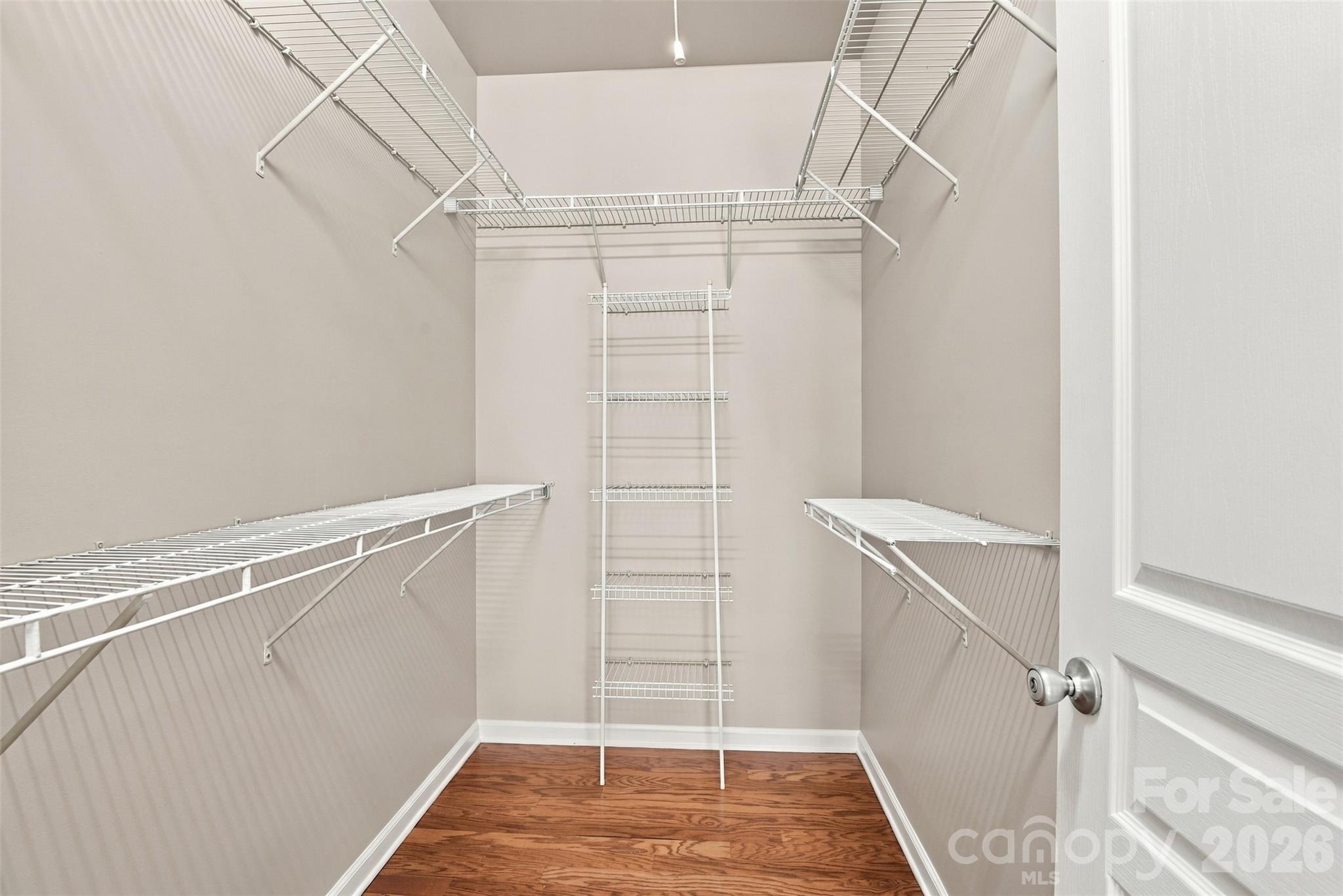 Walk-in closet with lots of shelving in primary suite! - 608 Goldflower Drive, Rock Hill