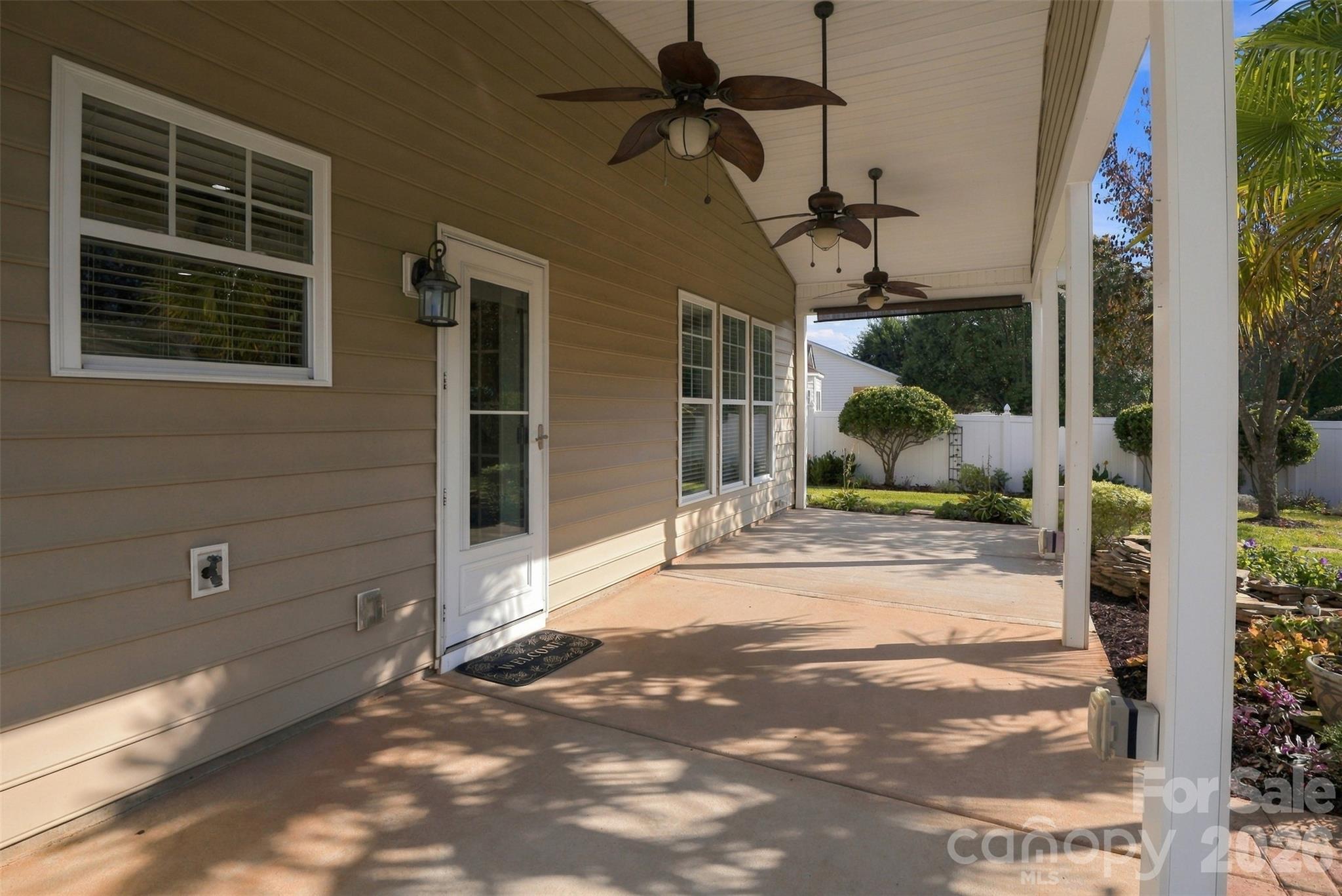 Back covered patio with 3 ceiling fans! Door leads into the kitchen. - 608 Goldflower Drive, Rock Hill