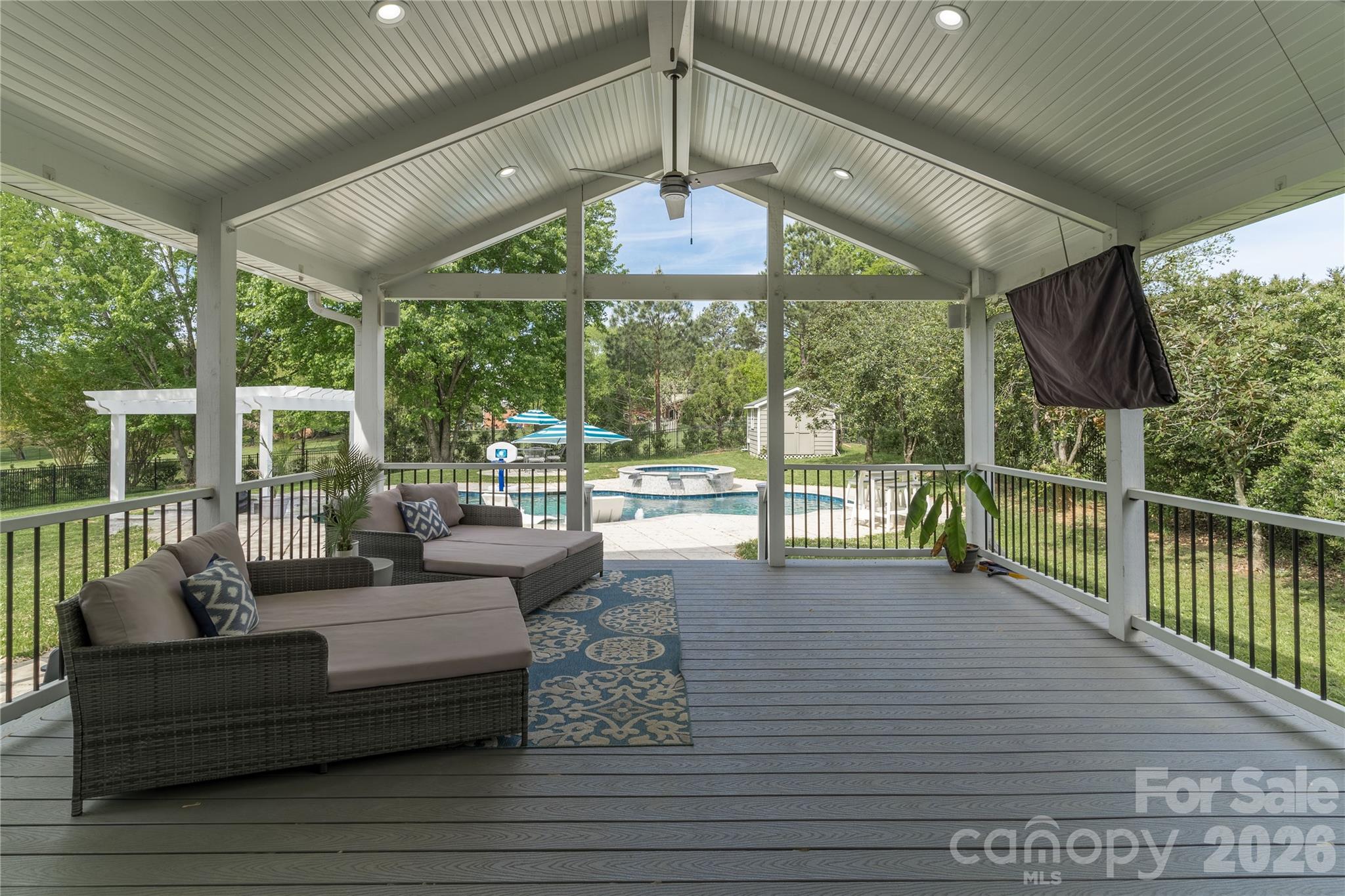 Enter your backyard oasis and enjoy cool summer nights on the large Trex covered patio overlooking the pool - 16647 Greenfarm Road, Huntersville