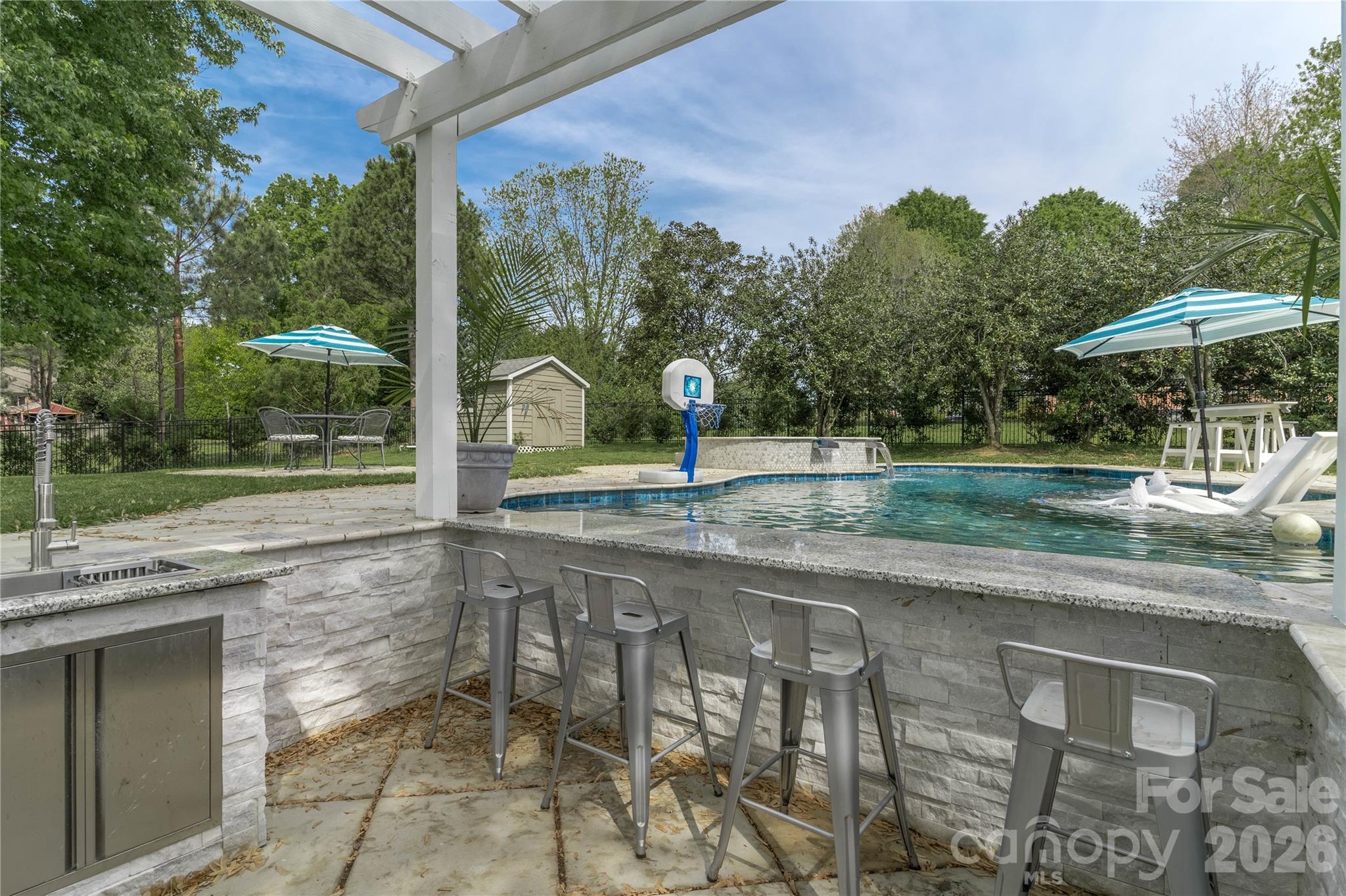 Entertain your guests using the in-ground gas grill, ice maker, granite outdoor kitchen with sink and more! - 16647 Greenfarm Road, Huntersville