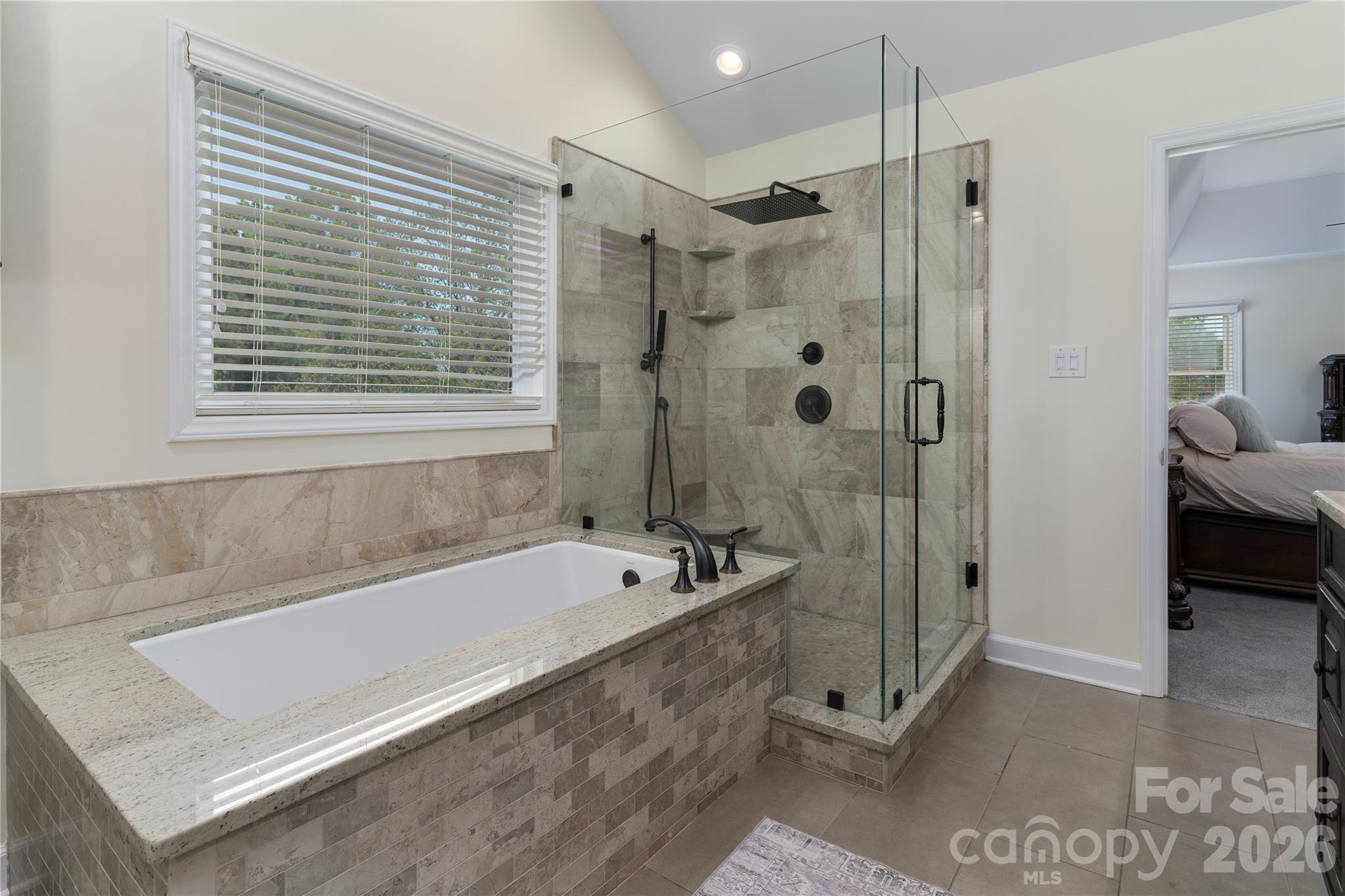The luxurious Ensuite Master Bathroom has custom cabinetry, along with granite and marble - 16647 Greenfarm Road, Huntersville
