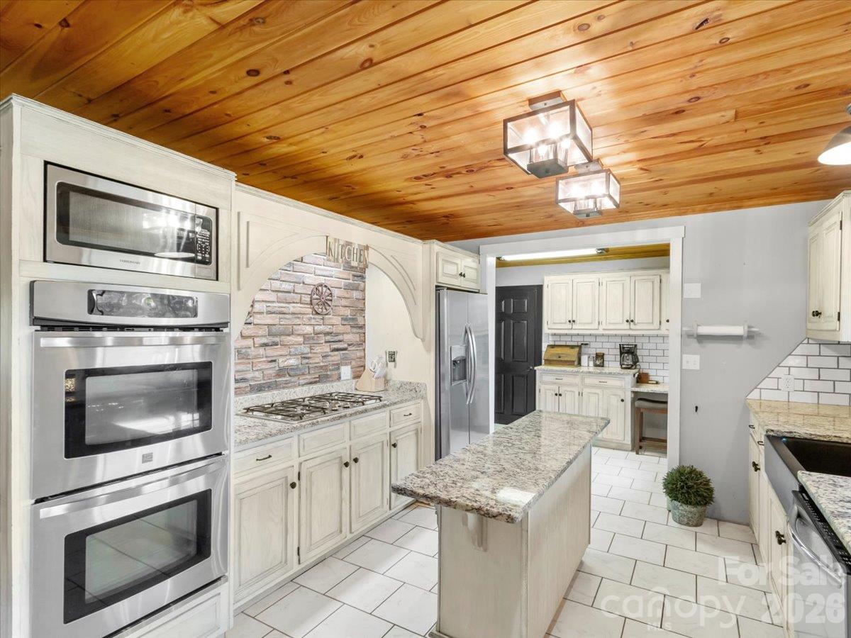 Kitchen- updated with stainless appliances, granite counters, double ovens and farmhouse sink - 179 River Walk Drive, Burnsville