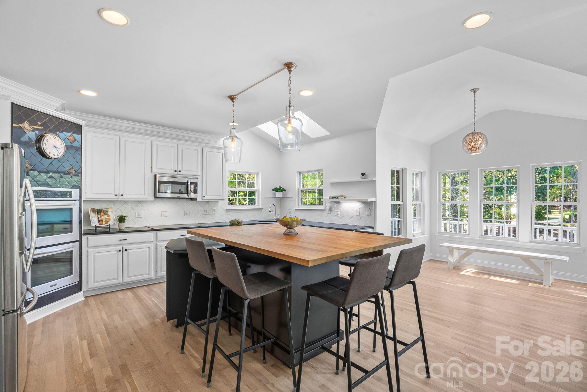 Kitchen with vaulted ceilings, skylights and breakfast room with French Doors to the outdoor upper patio - 148 Sunrise Circle, Mooresville