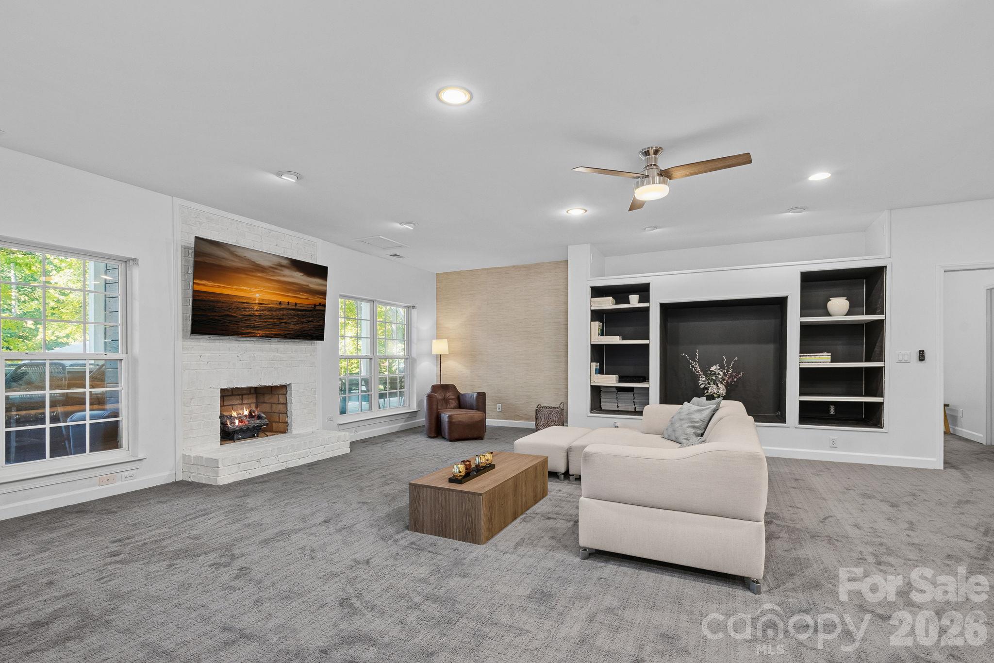 Basement living room with fireplace - 148 Sunrise Circle, Mooresville