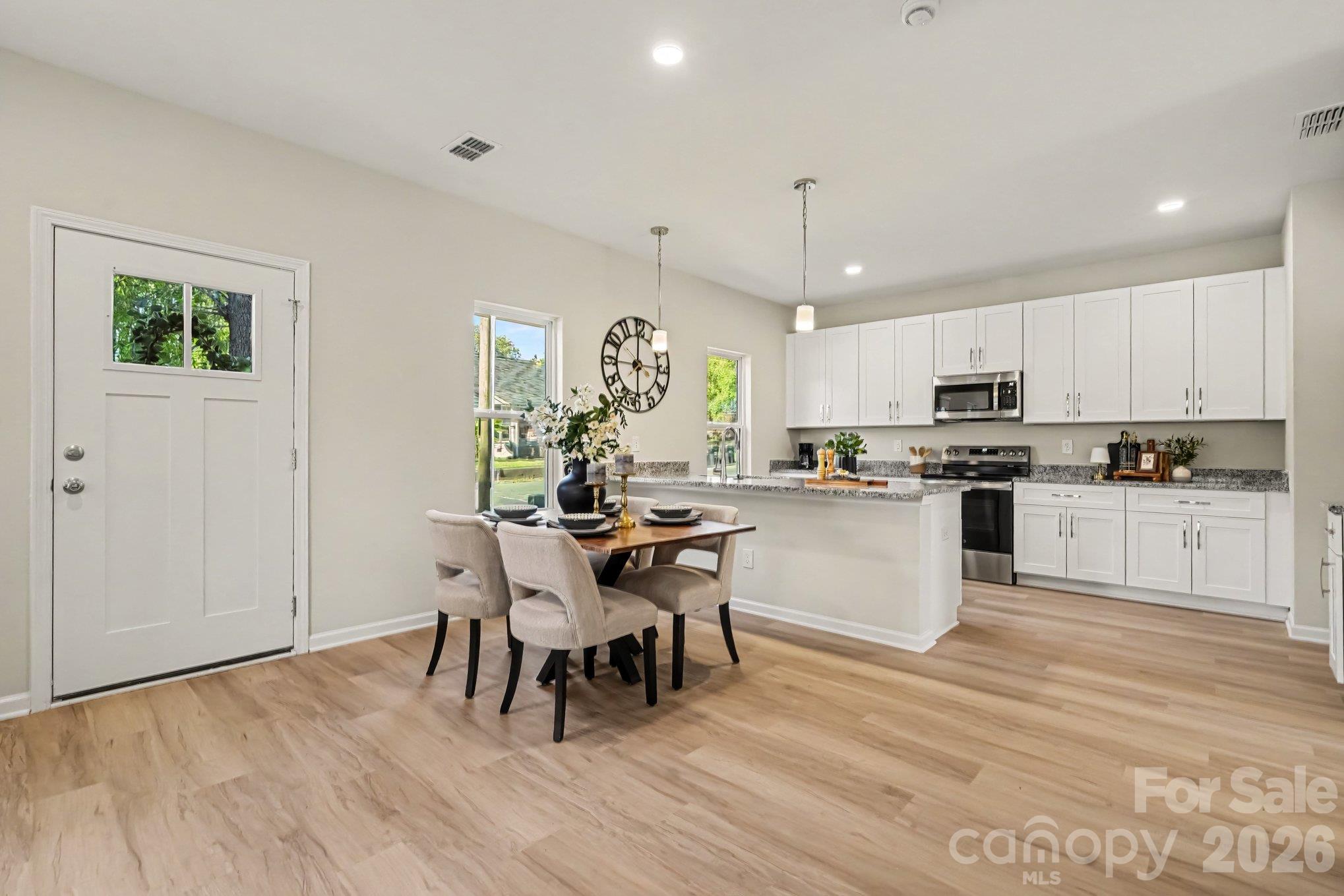 Dining area and kitchen. Pantry not in view but is to the right of this photo. - 121 Buffalo Avenue NW, Concord