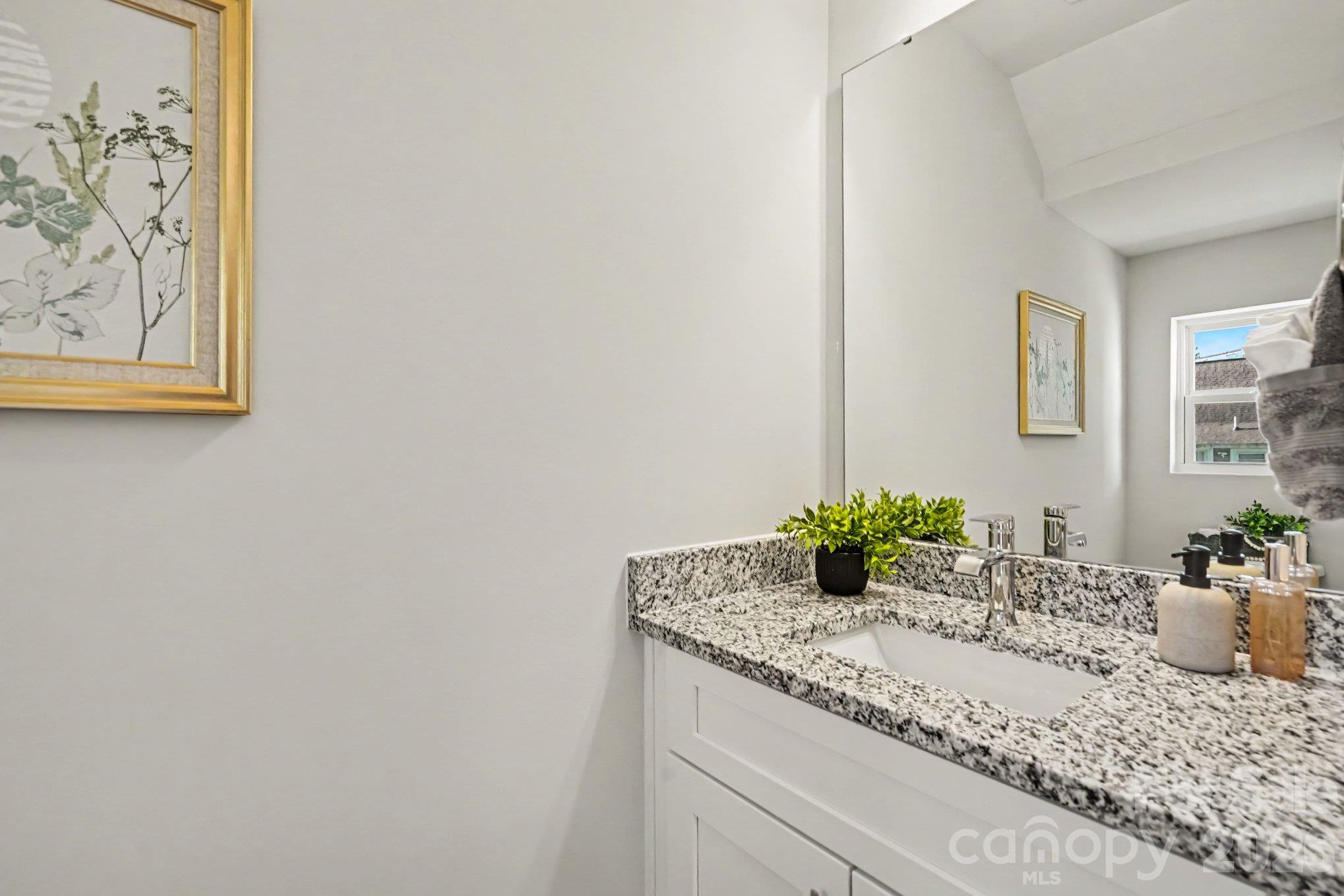 Half bathroom on main level has granite countertops. - 121 Buffalo Avenue NW, Concord