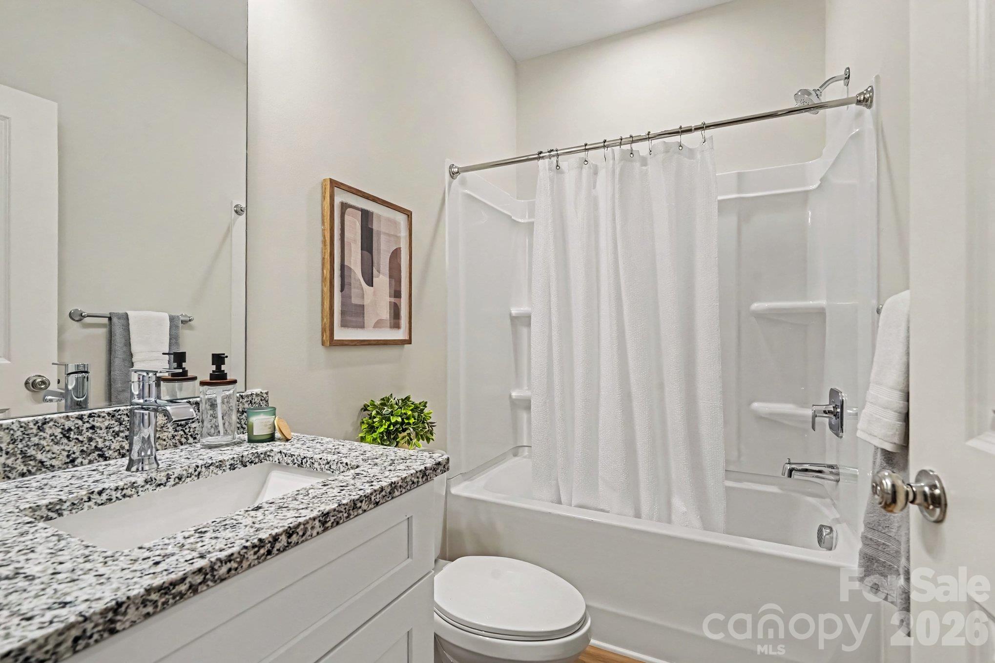 Full bathroom in upper hallway has granite countertops with shower/tub combo. - 121 Buffalo Avenue NW, Concord