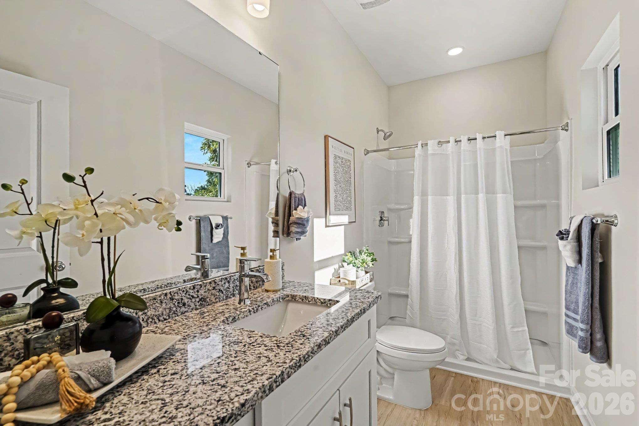 Primary full bathroom with stand up shower and granite countertop. Single vanity. - 121 Buffalo Avenue NW, Concord