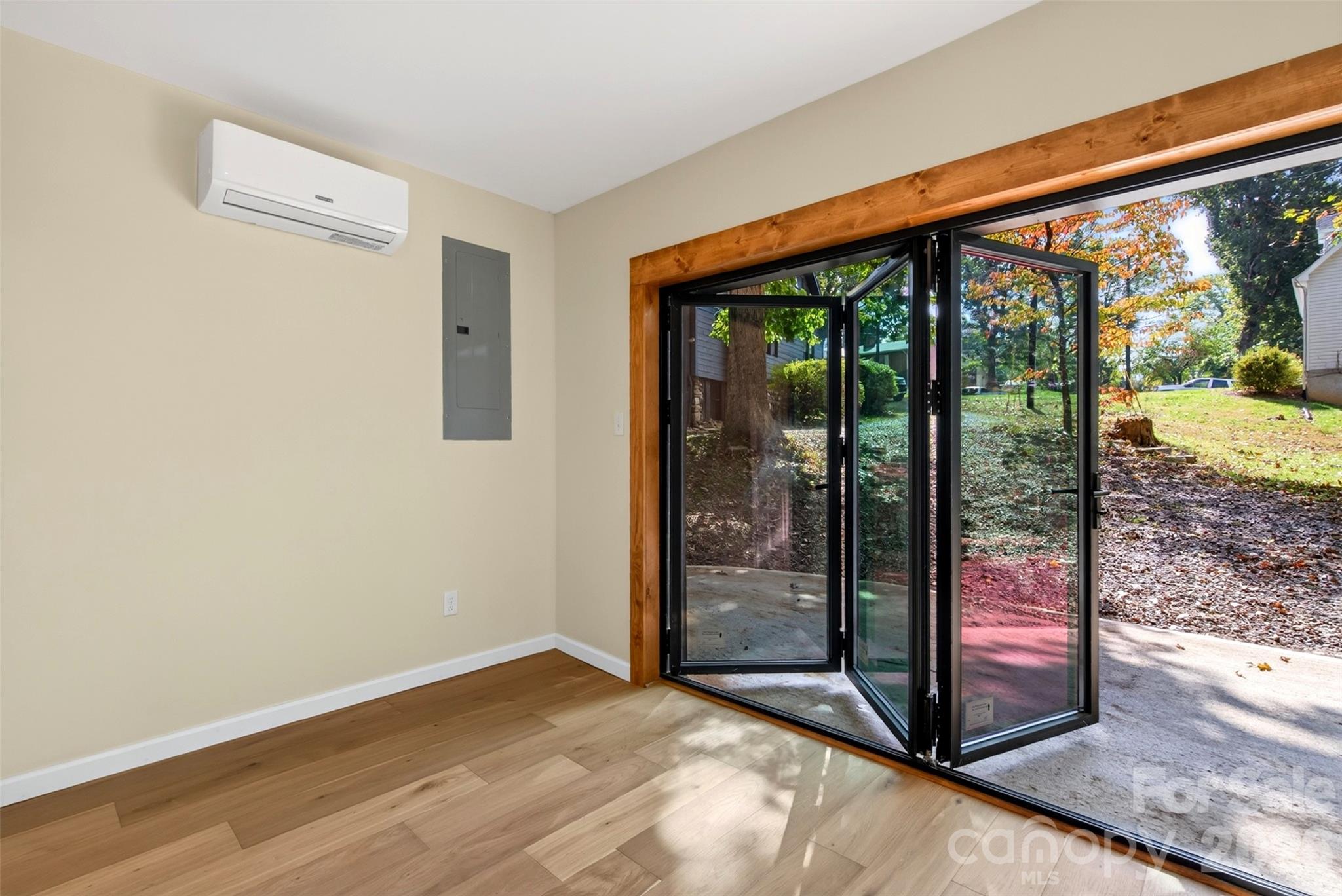 Accordion doors off the downstairs office brings the outside in. - 64 and 56 Pine Cone Drive, Asheville