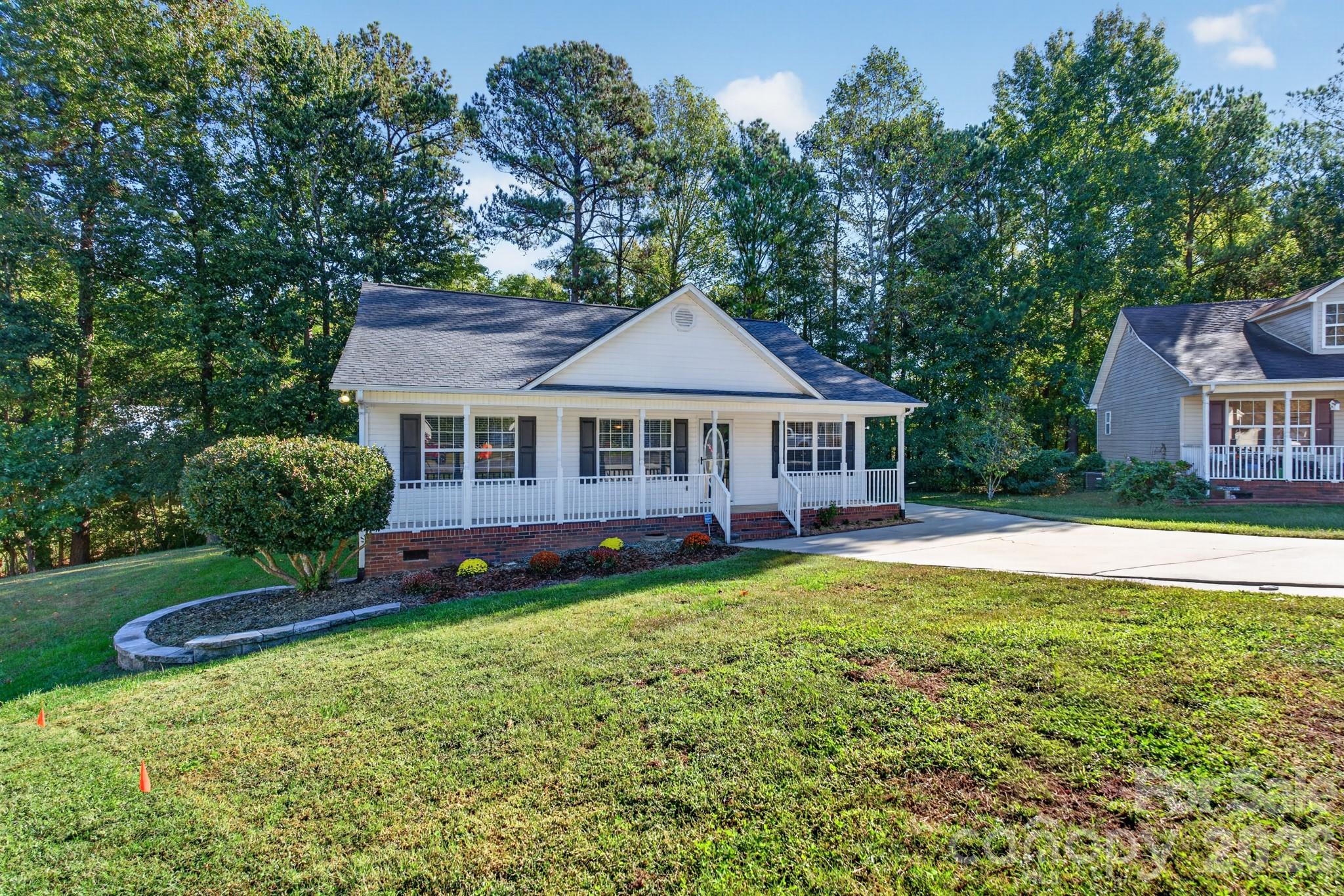 Nestled on a quiet, serene property surrounded by mature trees and lush, low-maintenance landscaping. - 702 Painted Lady Court, Rock Hill