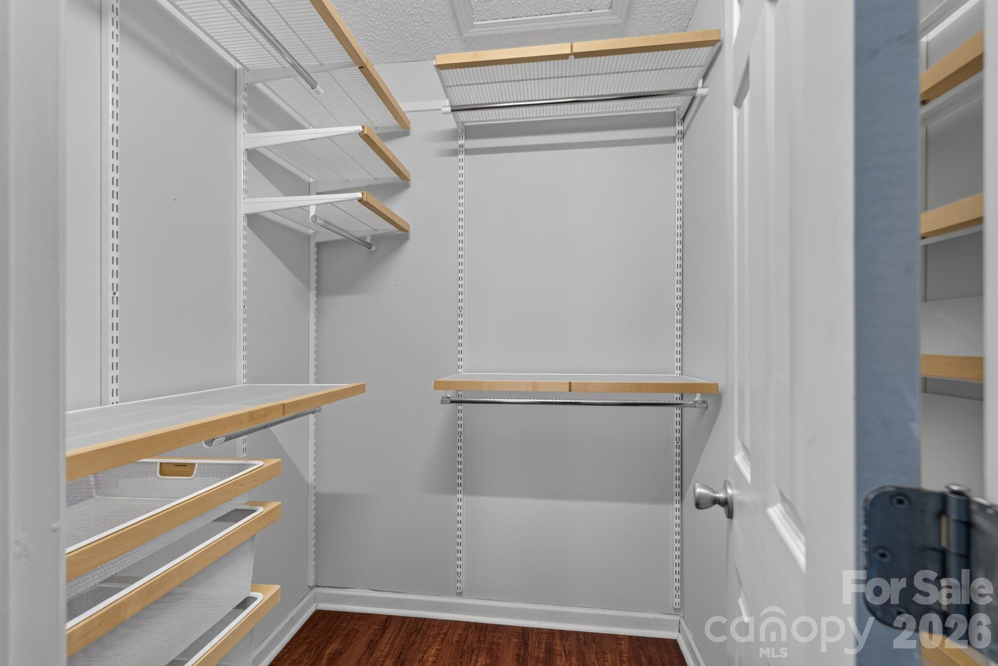 Generous walk-in closet with built-in custom wire shelving for maximum organization. - 702 Painted Lady Court, Rock Hill