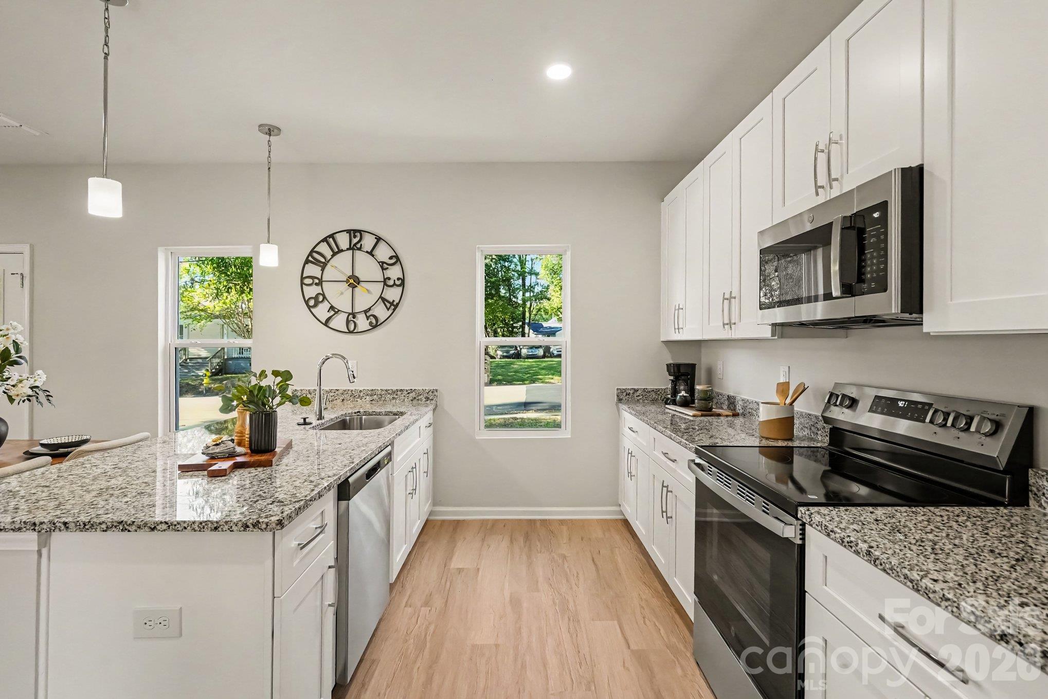 Nice size kitchen with dishwasher, disposal, electric range and microwave. This photo is a representation of home taken from identical home next door. Actual photos are in process. - 125 Buffalo Avenue NW, Concord