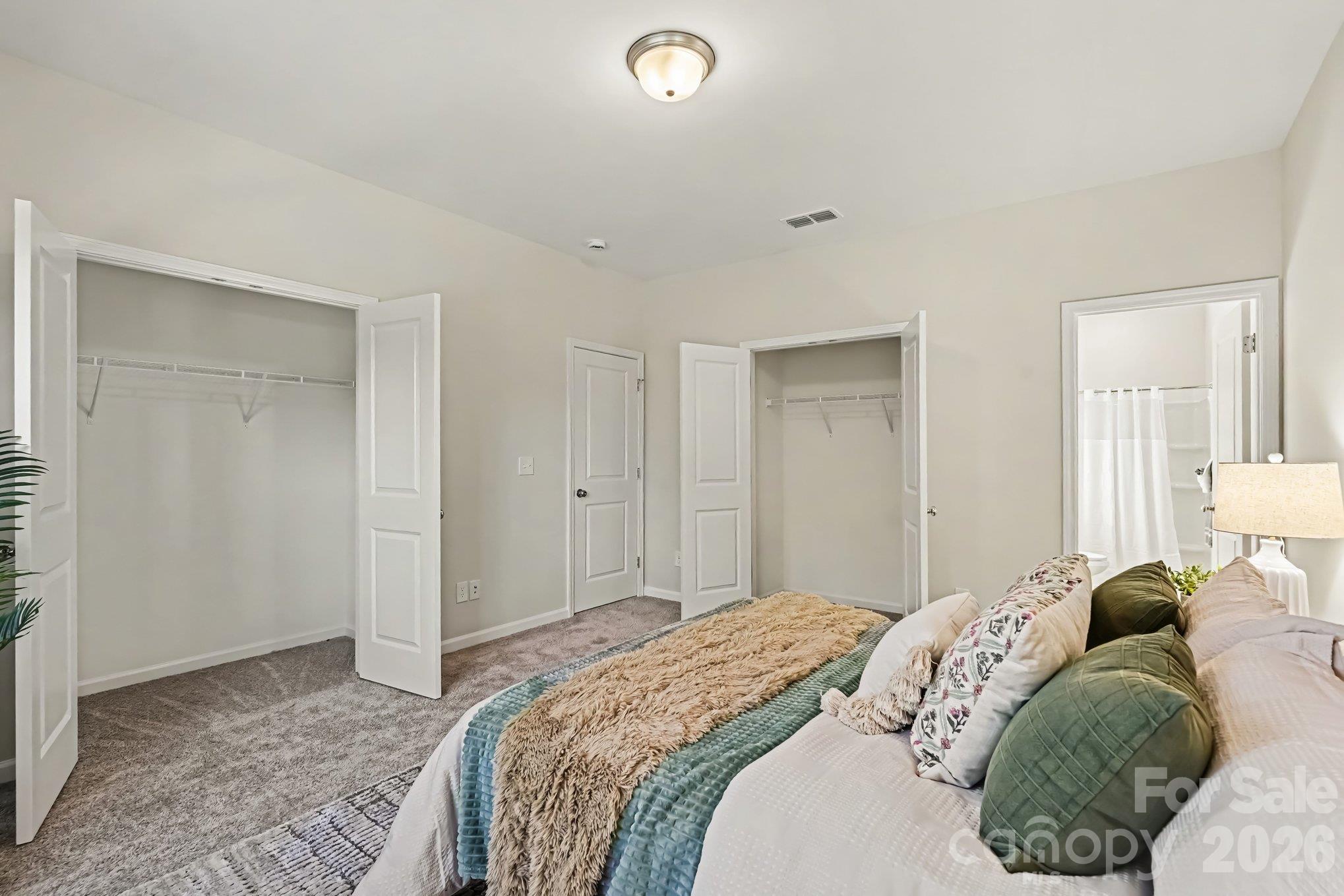 Primary bedroom view of two closets, entrance to the ensuite bathroom. - 125 Buffalo Avenue NW, Concord