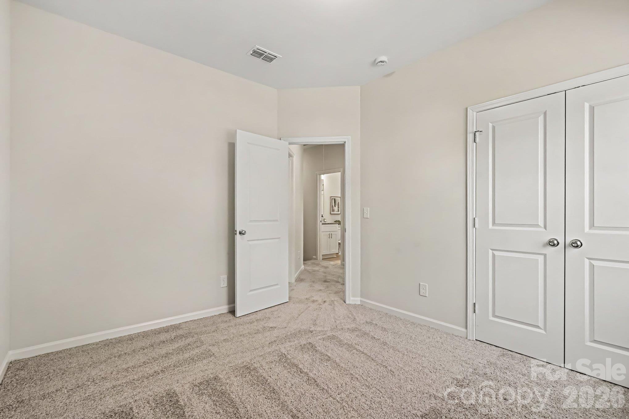 View from one of the bedrooms looking into hallway and second floor full bath. - 125 Buffalo Avenue NW, Concord