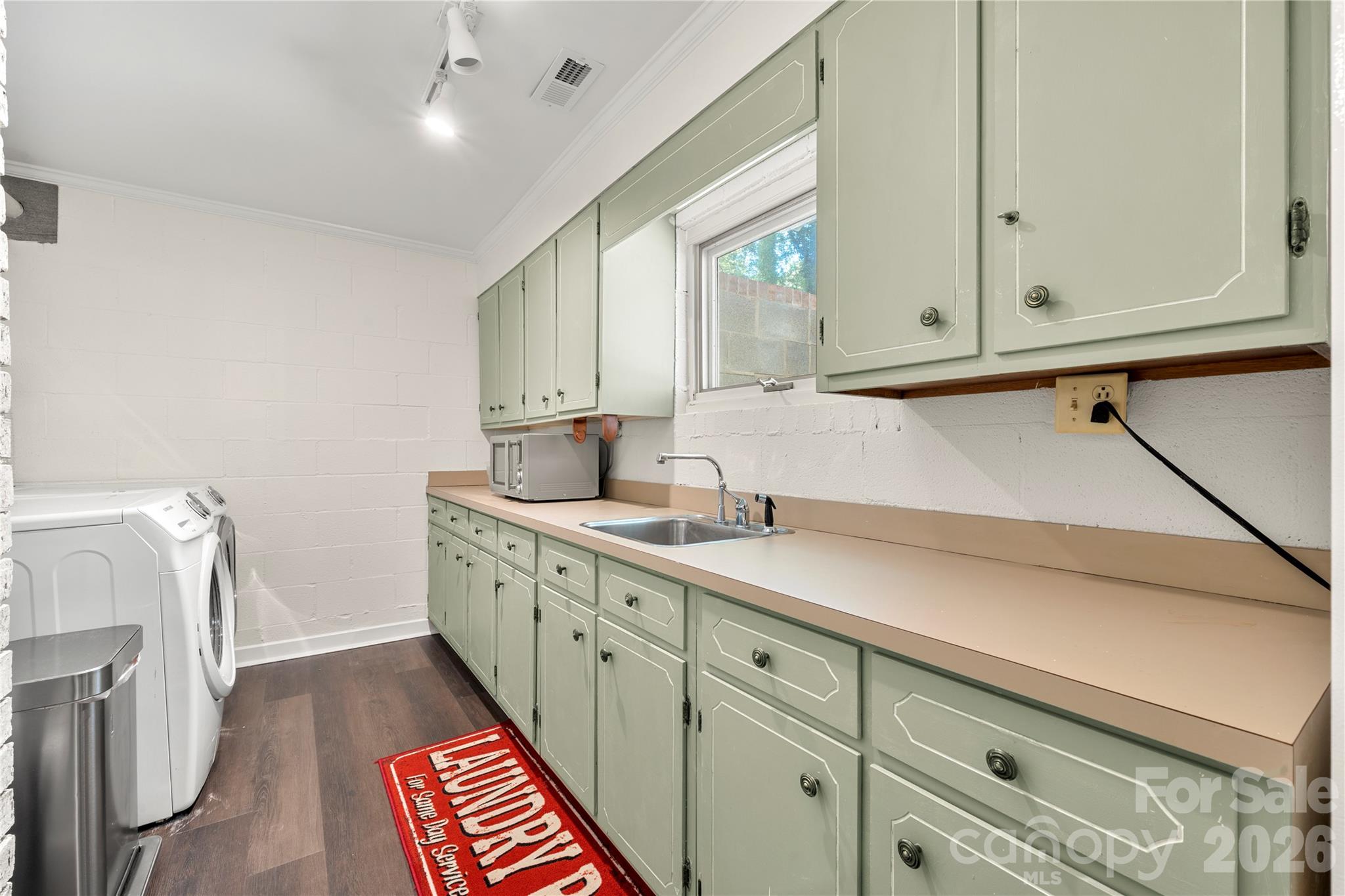Laundry room with sink, tons of cabinets, and a fridge. - 6 Oakwood Court, Clover