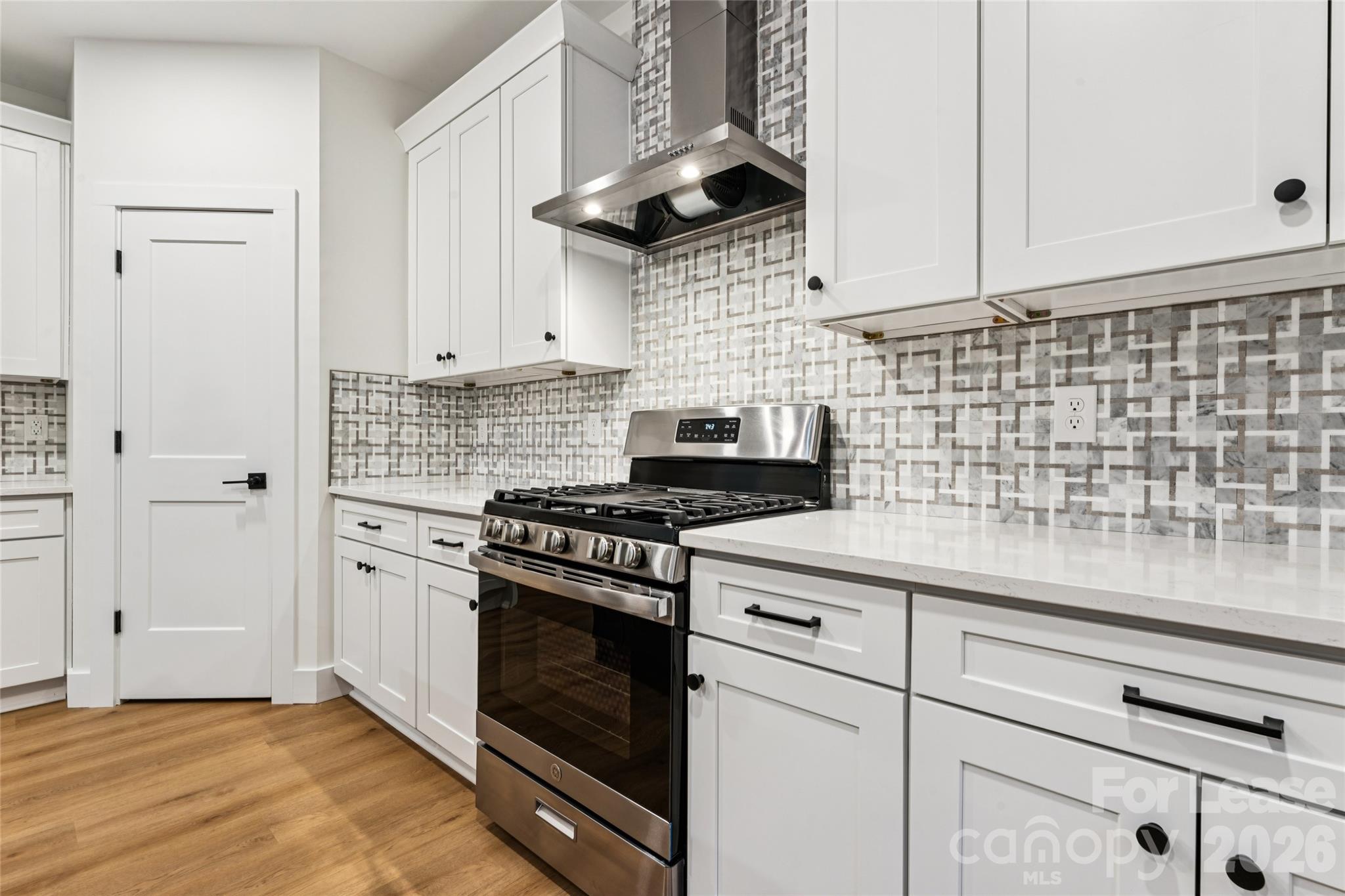 Kitchen with large island, stainless steel appliances, farm sink and backsplash - 11924 Crabapple Lane, Huntersville
