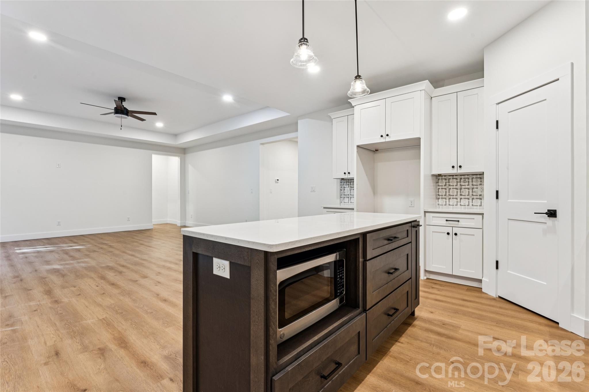 Kitchen with large island, stainless steel appliances, farm sink and backsplash - 11924 Crabapple Lane, Huntersville