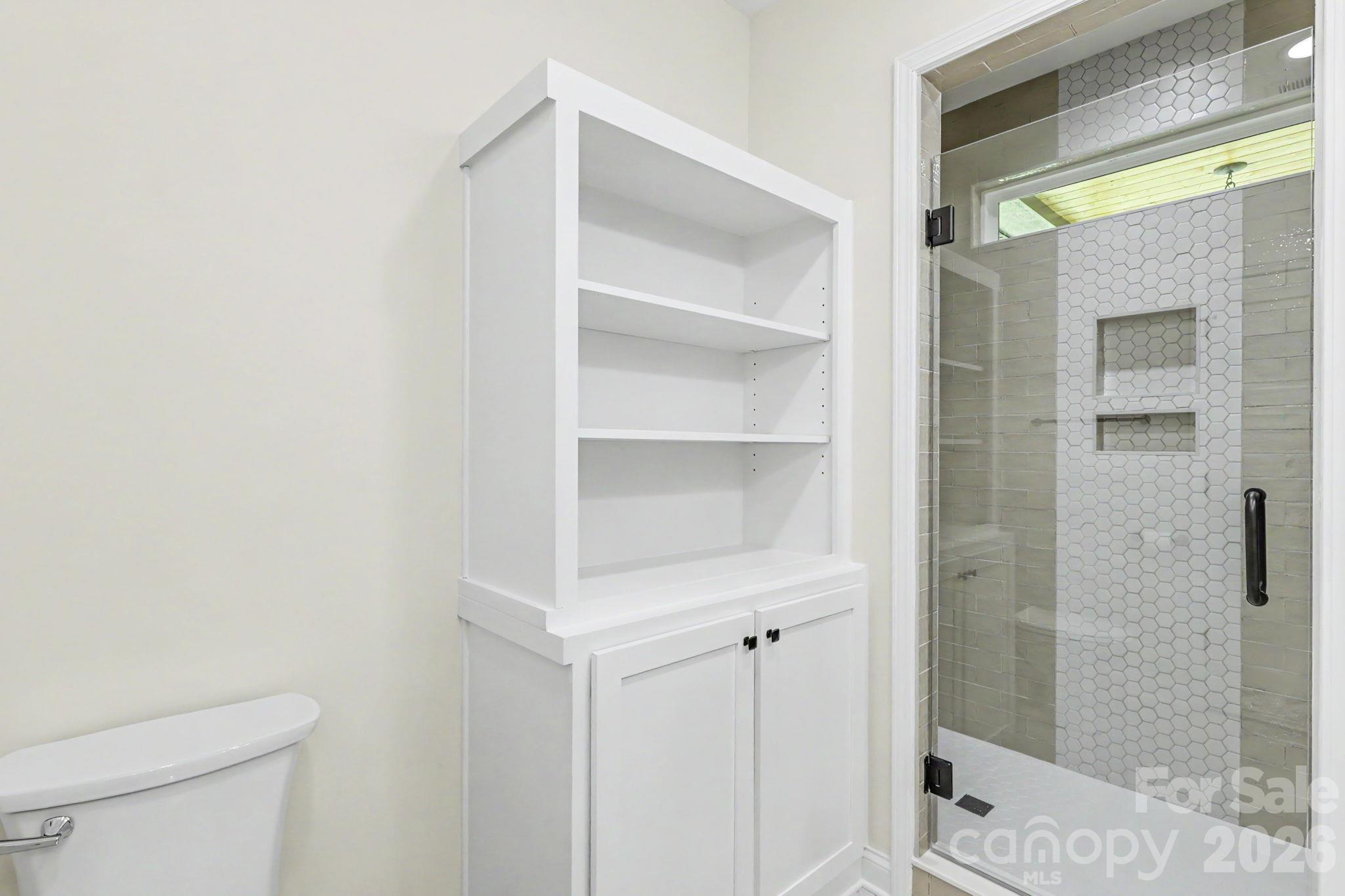 Primary bathroom with custom tile shower and cabinetry - 2121 Woodhurst Lane, Albemarle