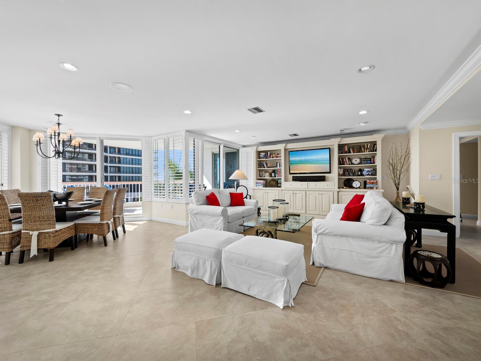 Designed for gracious entertaining and easy living, the living/dining area offers dual aspect views and direct access to both balconies. Built-ins and millwork elevate coastal living with simple elegance. - 455 LONGBOAT CLUB RD #402, LONGBOAT KEY