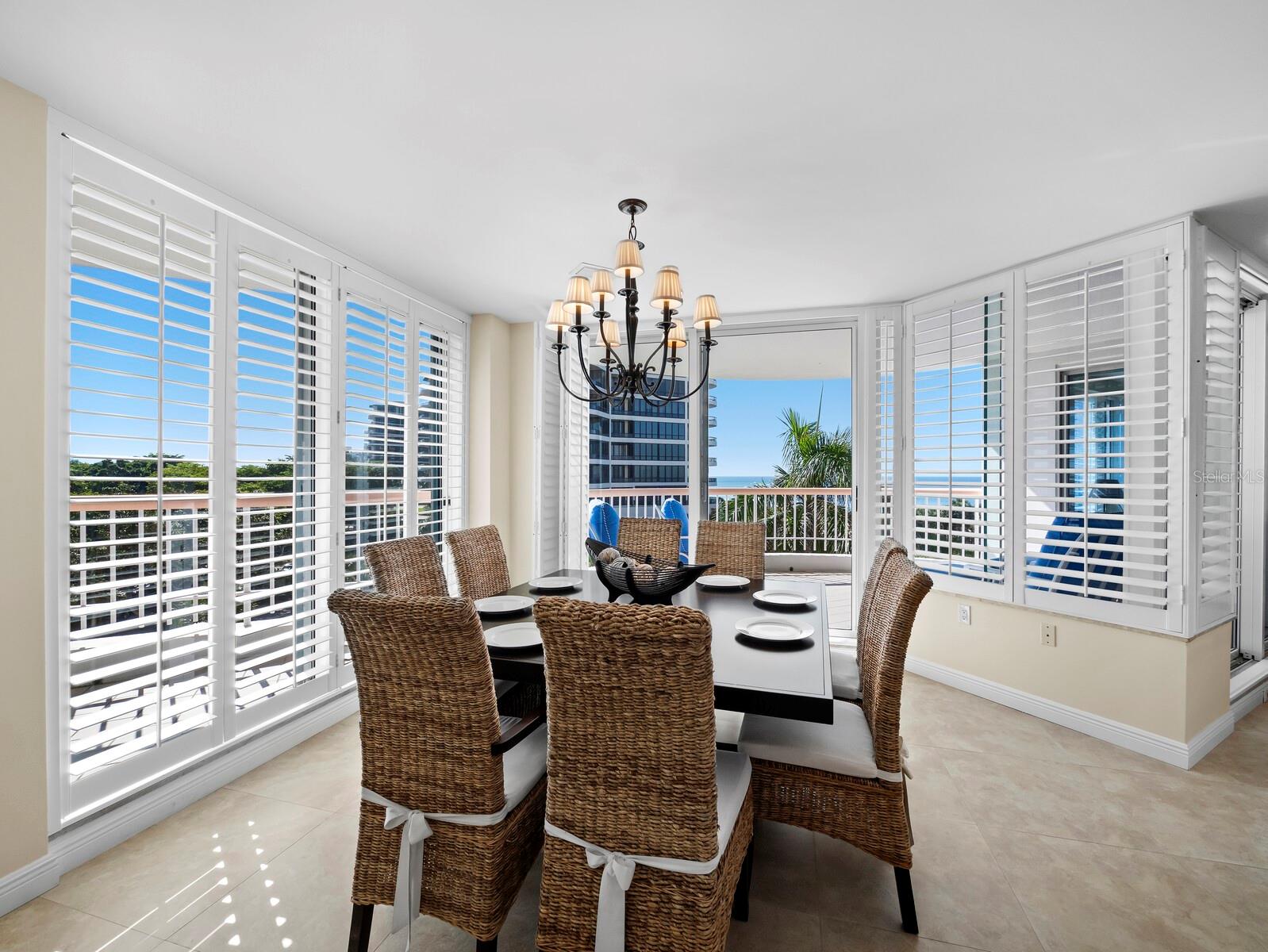 Dining area easily accommodates this table for eight, with exceptional views - 455 LONGBOAT CLUB RD #402, LONGBOAT KEY