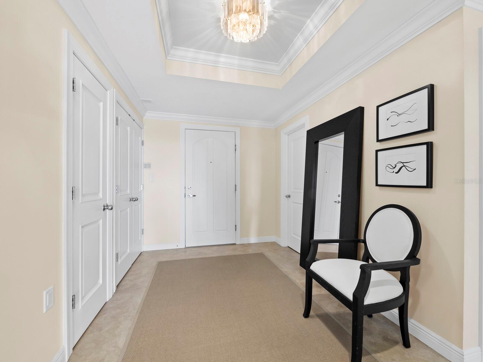 Entry Foyer with coffered ceiling, half bath and large closets - 455 LONGBOAT CLUB RD #402, LONGBOAT KEY