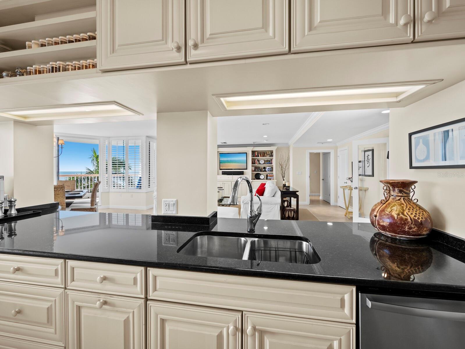 Kitchen with views to the living area and the Gulf beyond - 455 LONGBOAT CLUB RD #402, LONGBOAT KEY