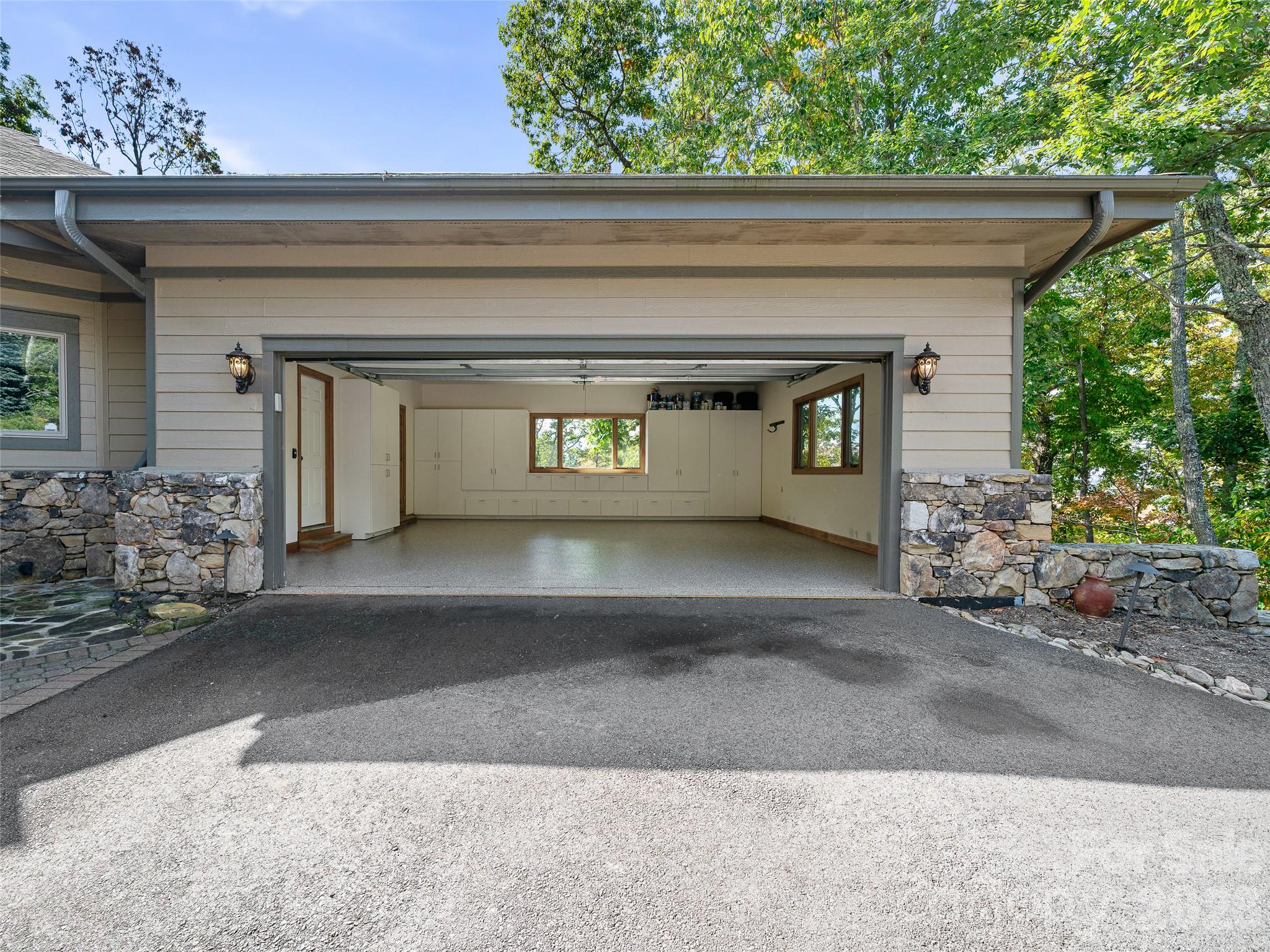 Extensive built-in cabinetry lines the garage walls - 151 Austin Mountain Drive, Burnsville