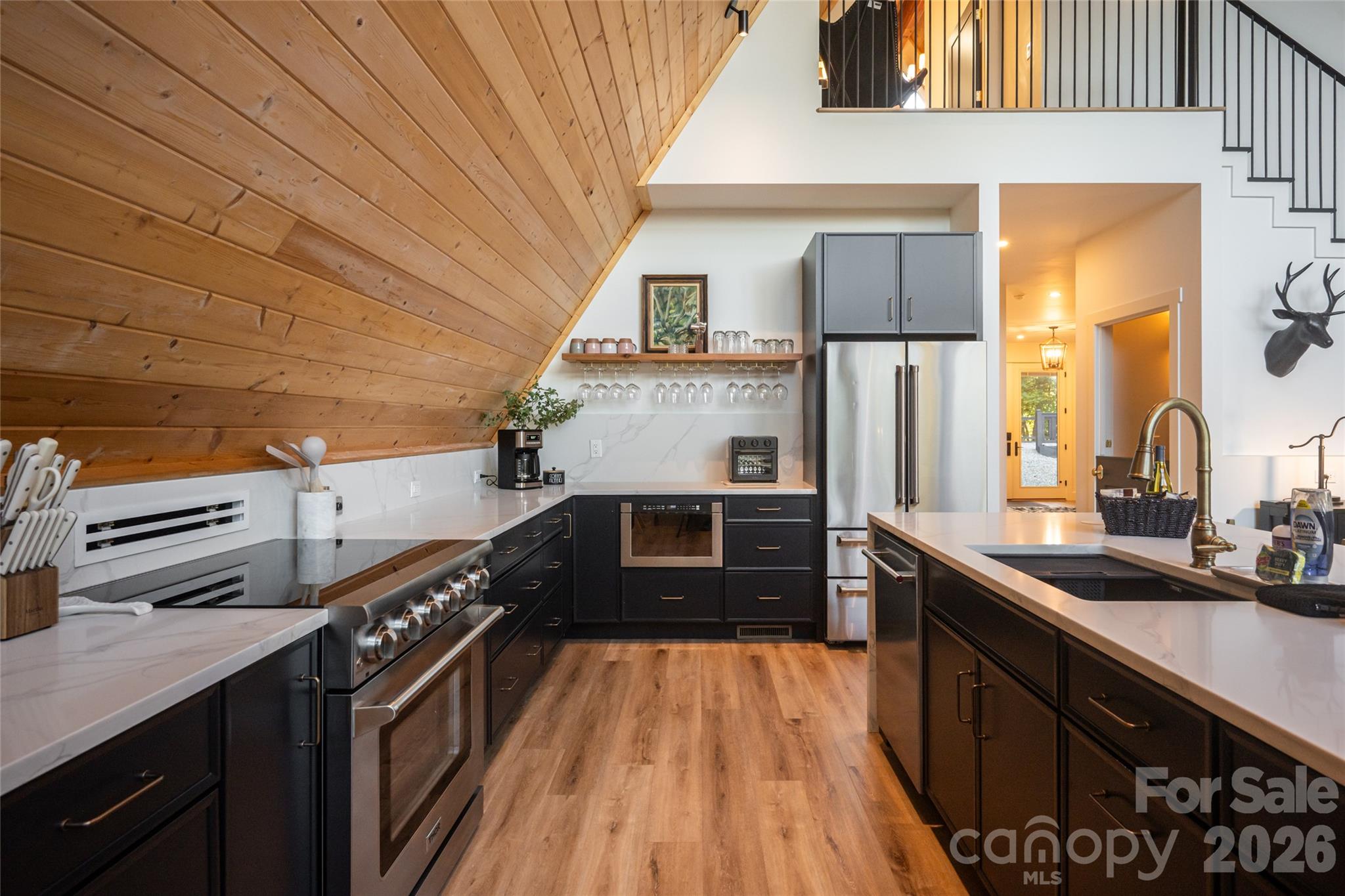 The kitchen features stainless steel appliances - 125 Carolina Lily Lane, Asheville