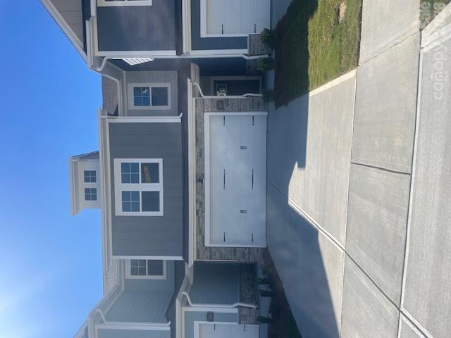 Exterior with stone accent around the 2 car garage. The driveway provides ample parking for you and your guests - 257 Alluvium Lane, Waxhaw