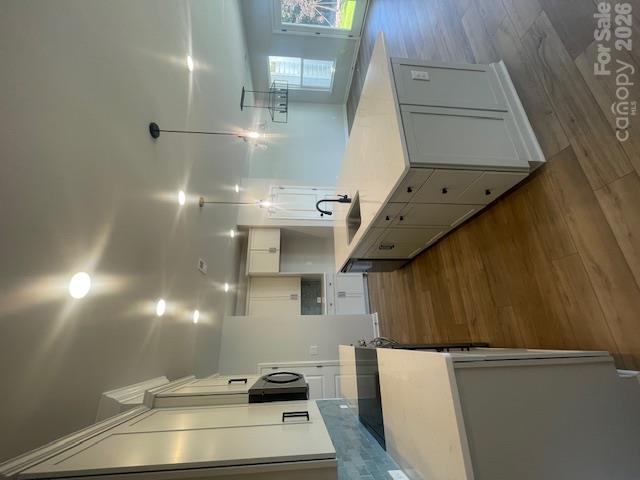 Kitchen features Frost color cabinets, quartz countertops. Tiled backsplash. LVP flooring throughout the main level - 257 Alluvium Lane, Waxhaw