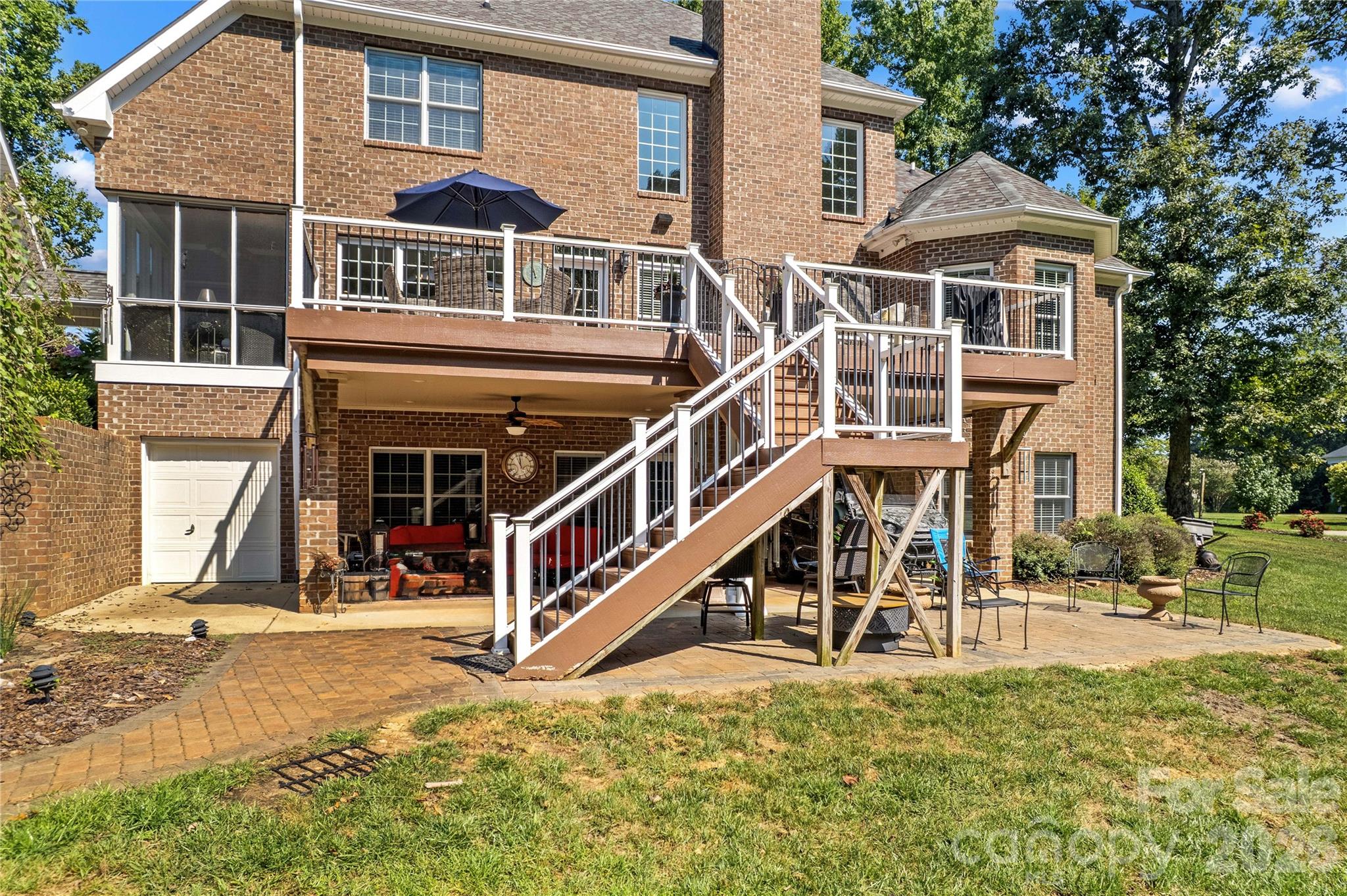 Back of home with covered patio, equipment garage access and large deck - 220 Cedar Lake Drive, Statesville