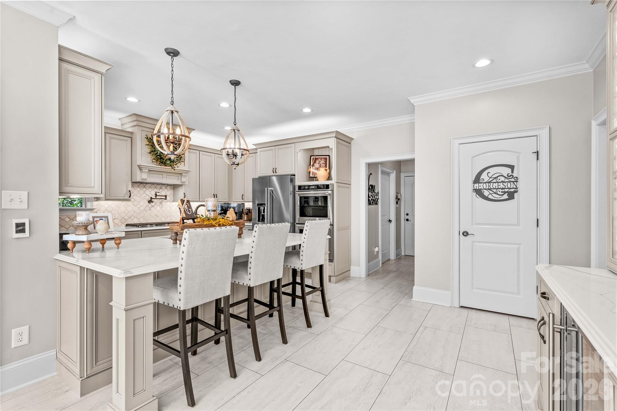 Open and bright kitchen with walk-in pantry,coffee/beverage bar and wine cooler - 220 Cedar Lake Drive, Statesville
