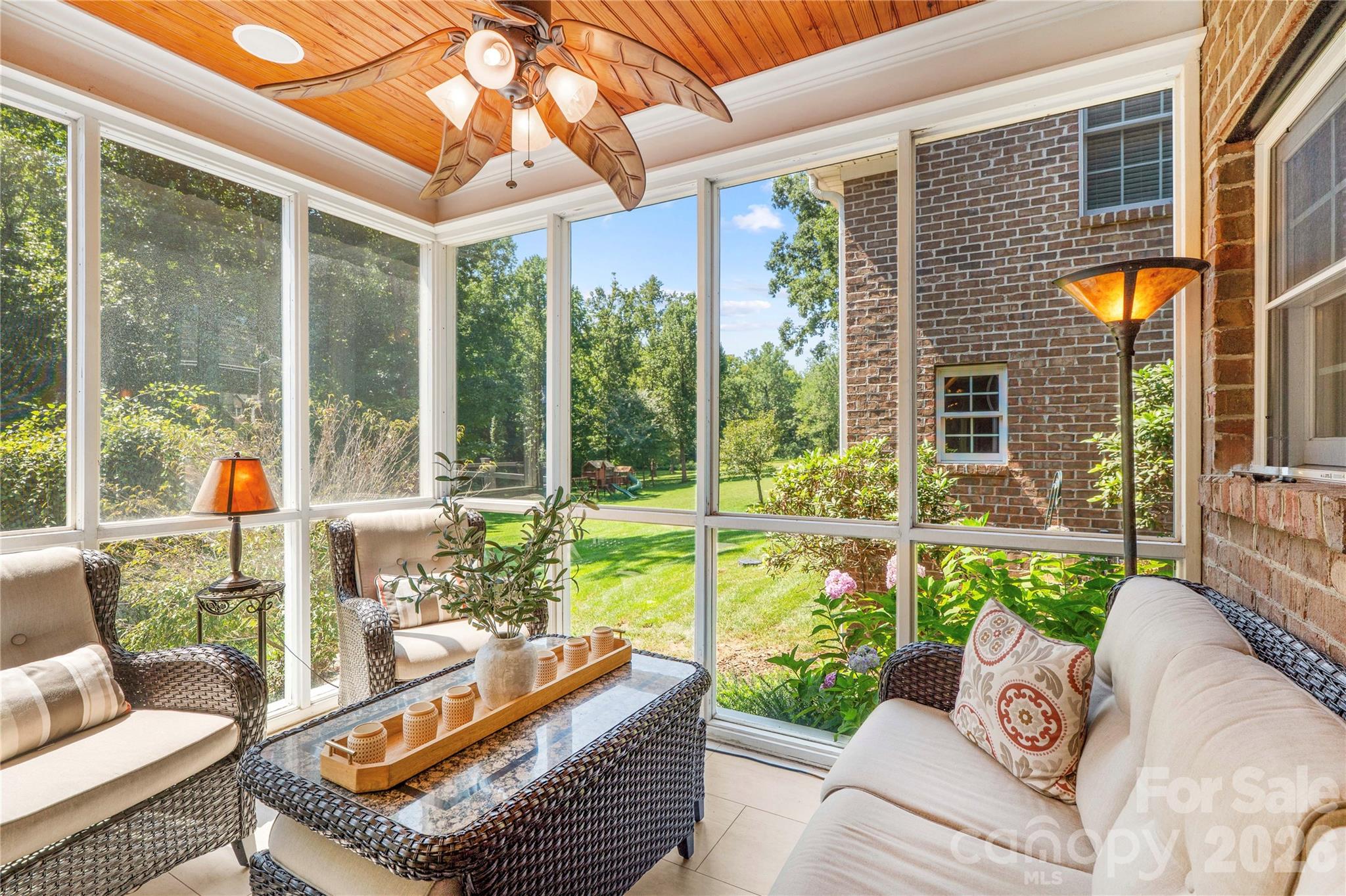 Cozy sun porch screened with glass inserts for cooler months - 220 Cedar Lake Drive, Statesville