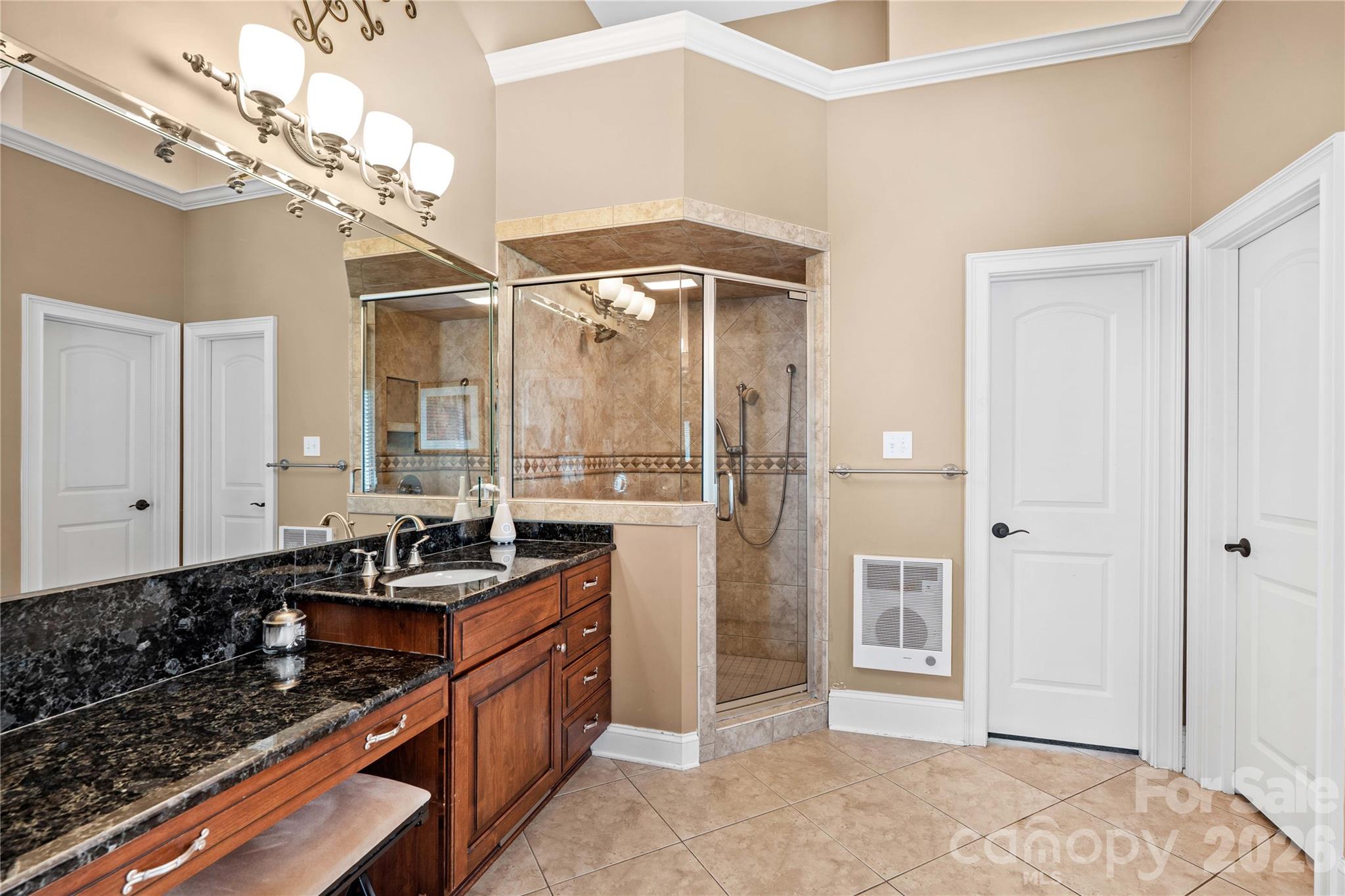 Primary bath with dual vanity spaces, walk in shower and large jetted tub - 220 Cedar Lake Drive, Statesville