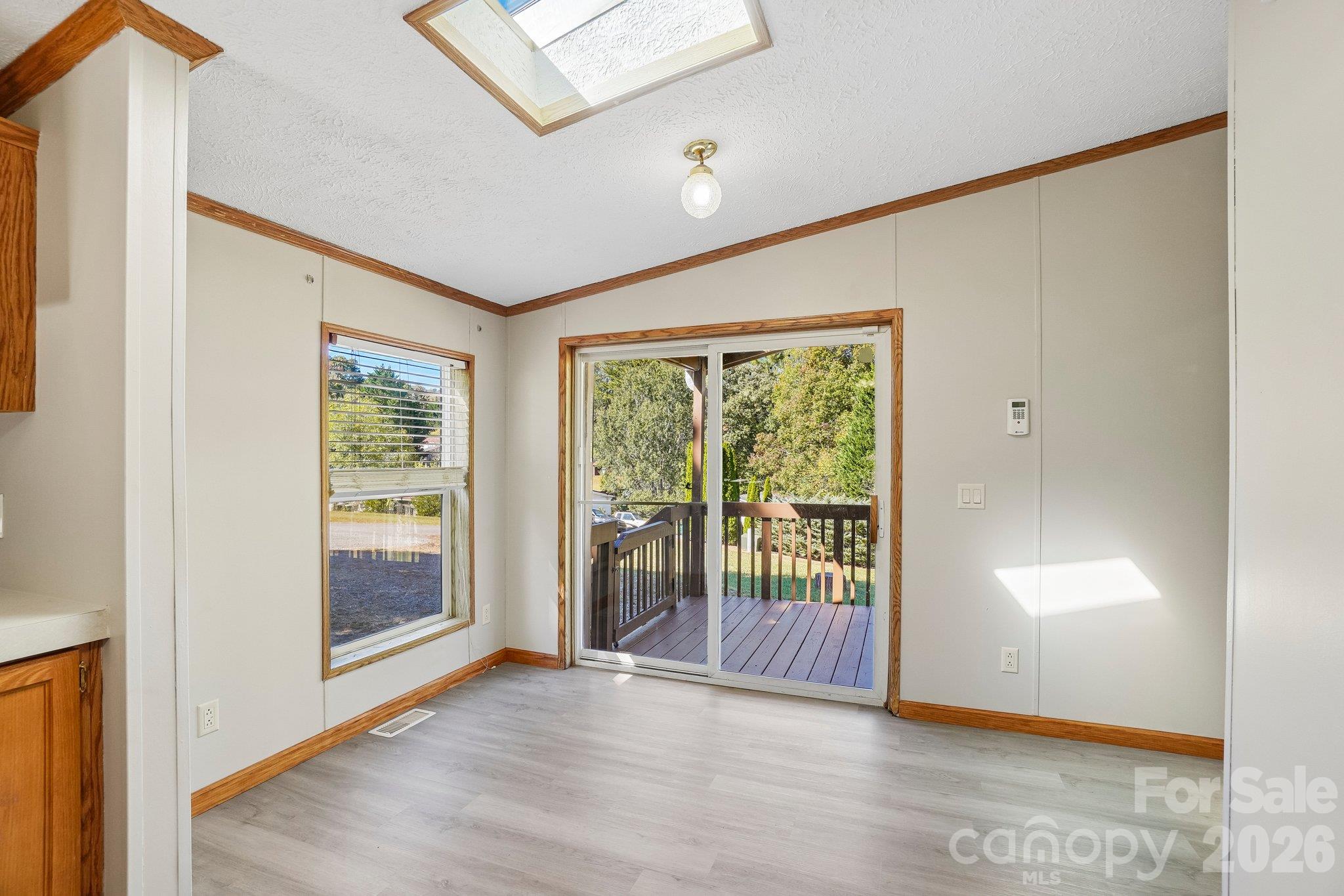 A dining area leads to a sliding door onto the covered deck. - 202 Banyan Road, Candler