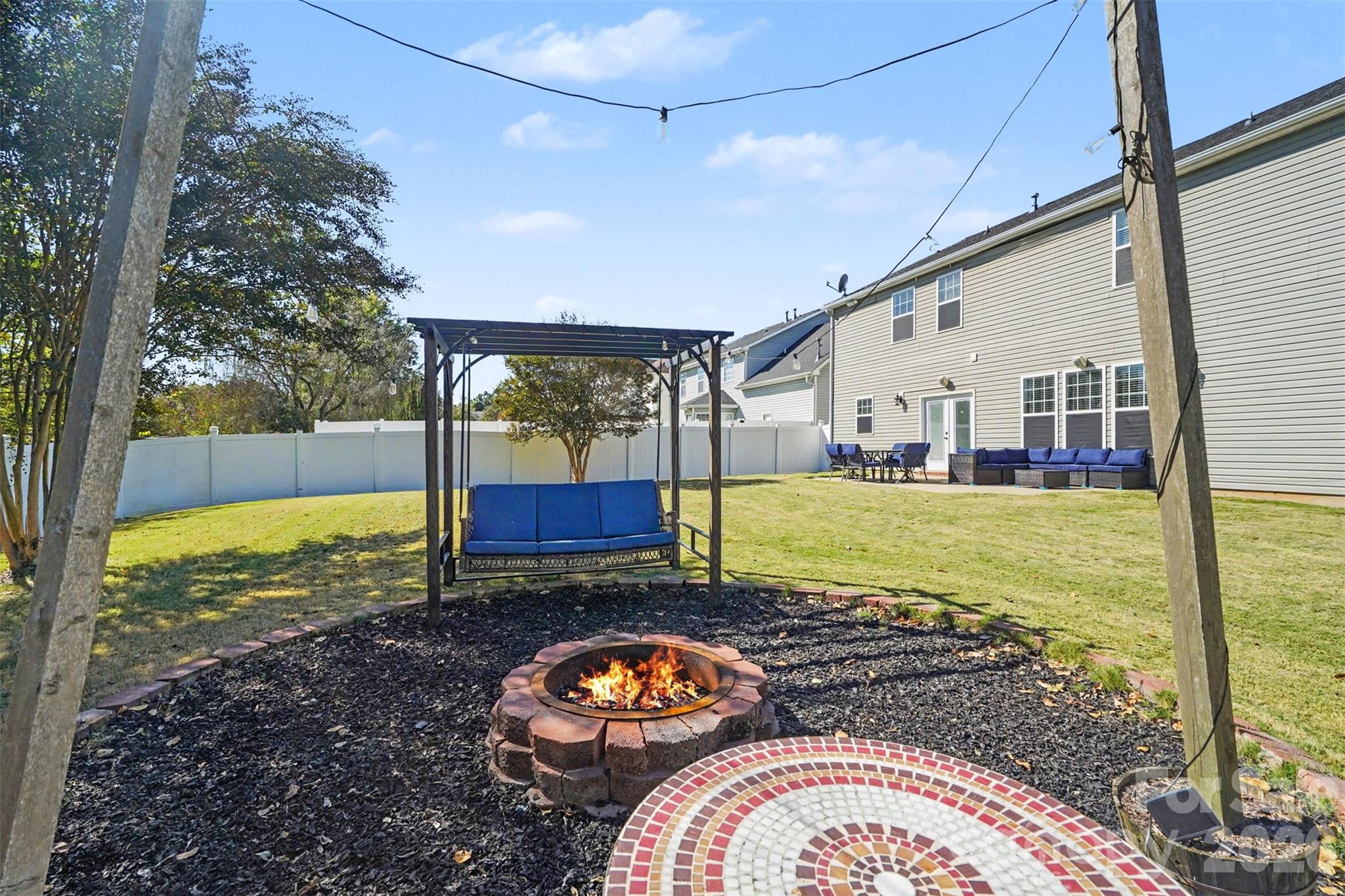 Enjoy evenings around the firepit in the spacious backyard. - 3585 Leighton Drive SW, Concord
