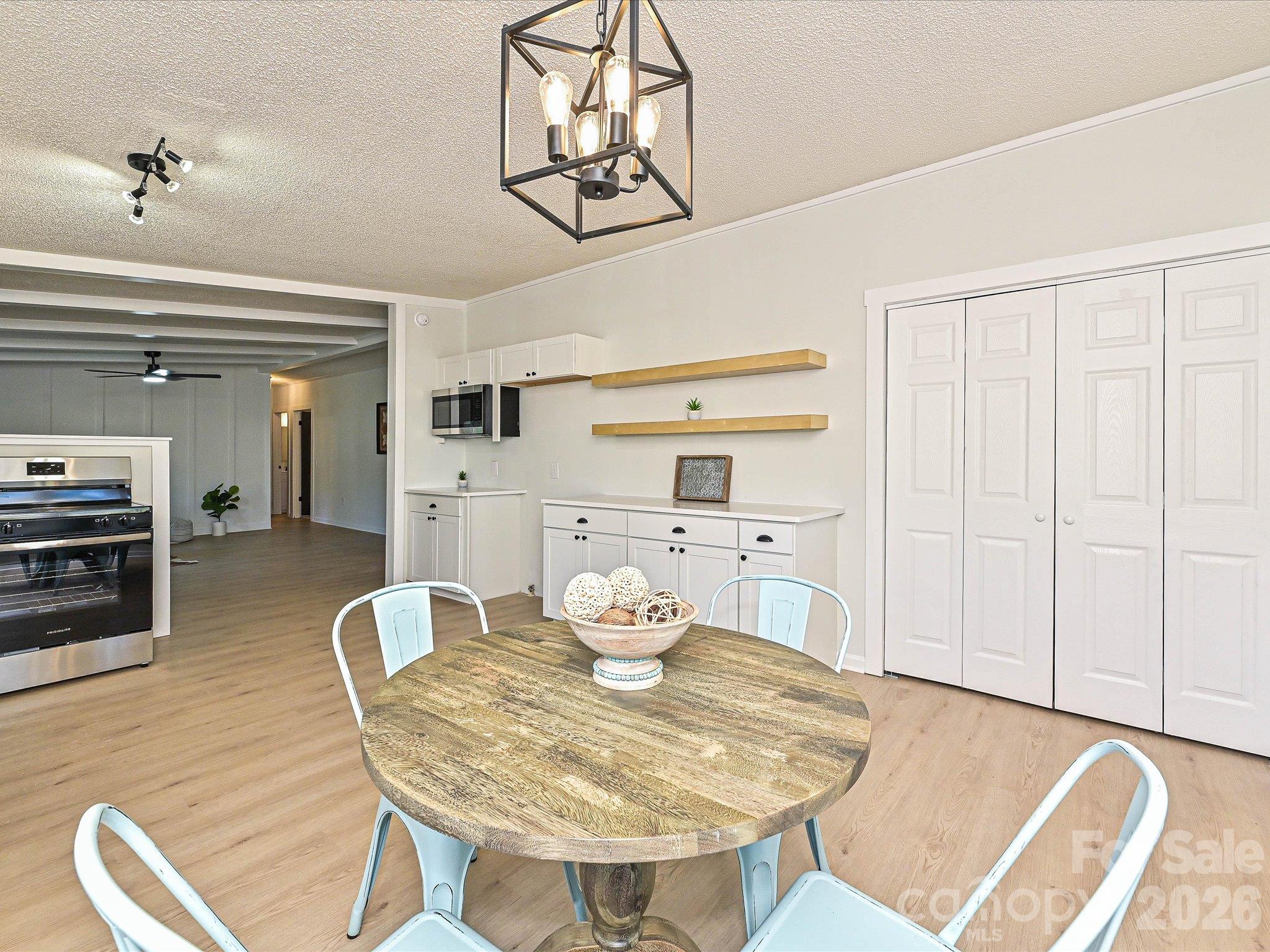 View of breakfast bar. on right hand side. of kitchen with custom shelving above. Washer dryer closet to the right. - 1711 Trexlar Avenue, Gastonia