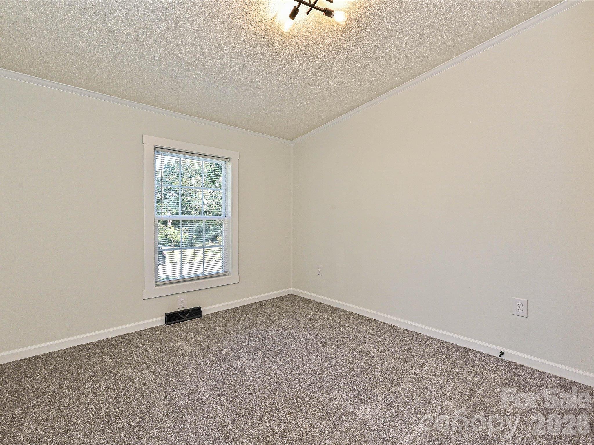 View of bedroom #2 with fresh new carpet, paint, blinds and light fixture. - 1711 Trexlar Avenue, Gastonia
