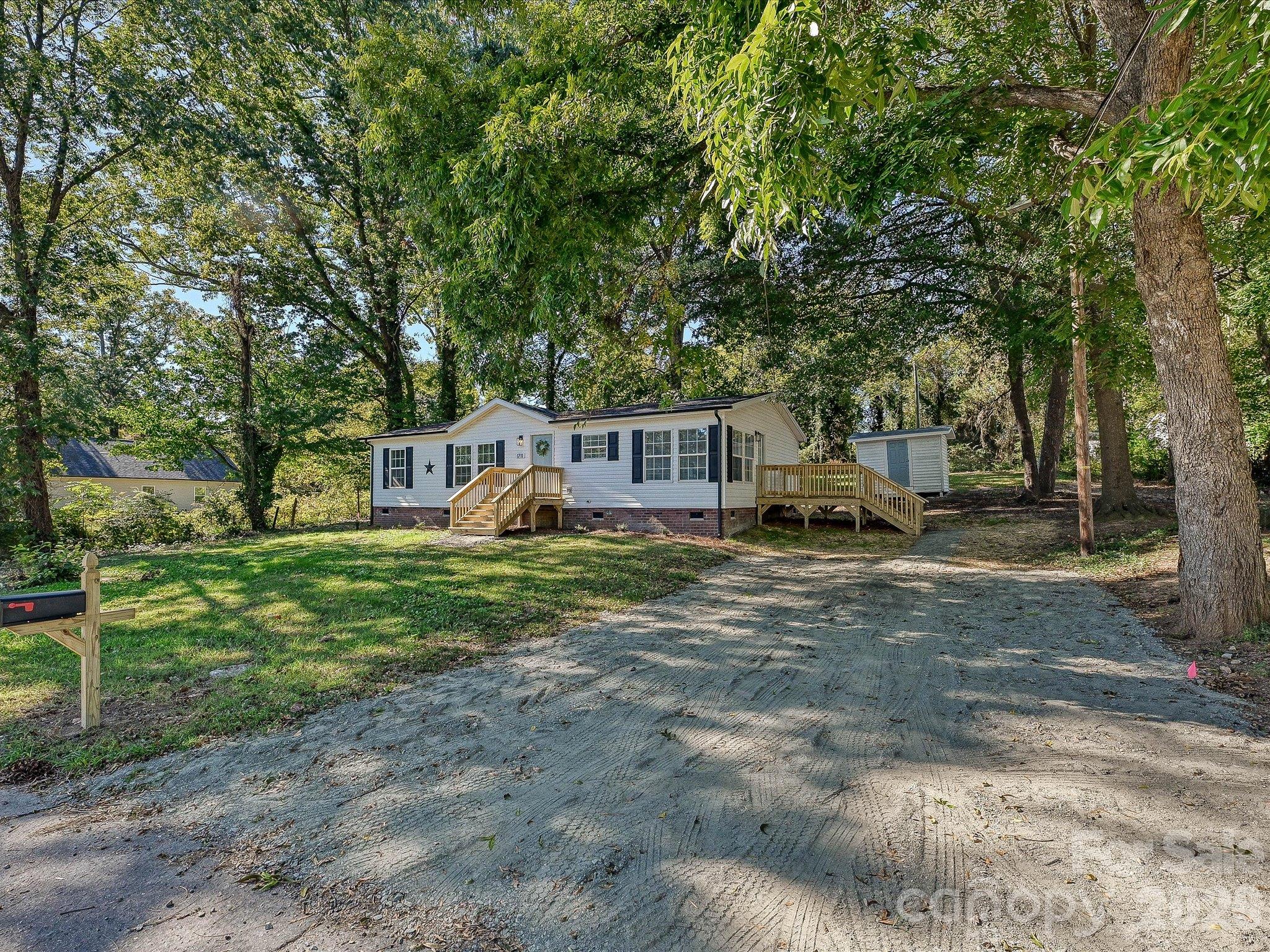 View of home from the front right hand side from street. New gravel driveway and front & side decks! New Architectural Roof and gutters! - 1711 Trexlar Avenue, Gastonia