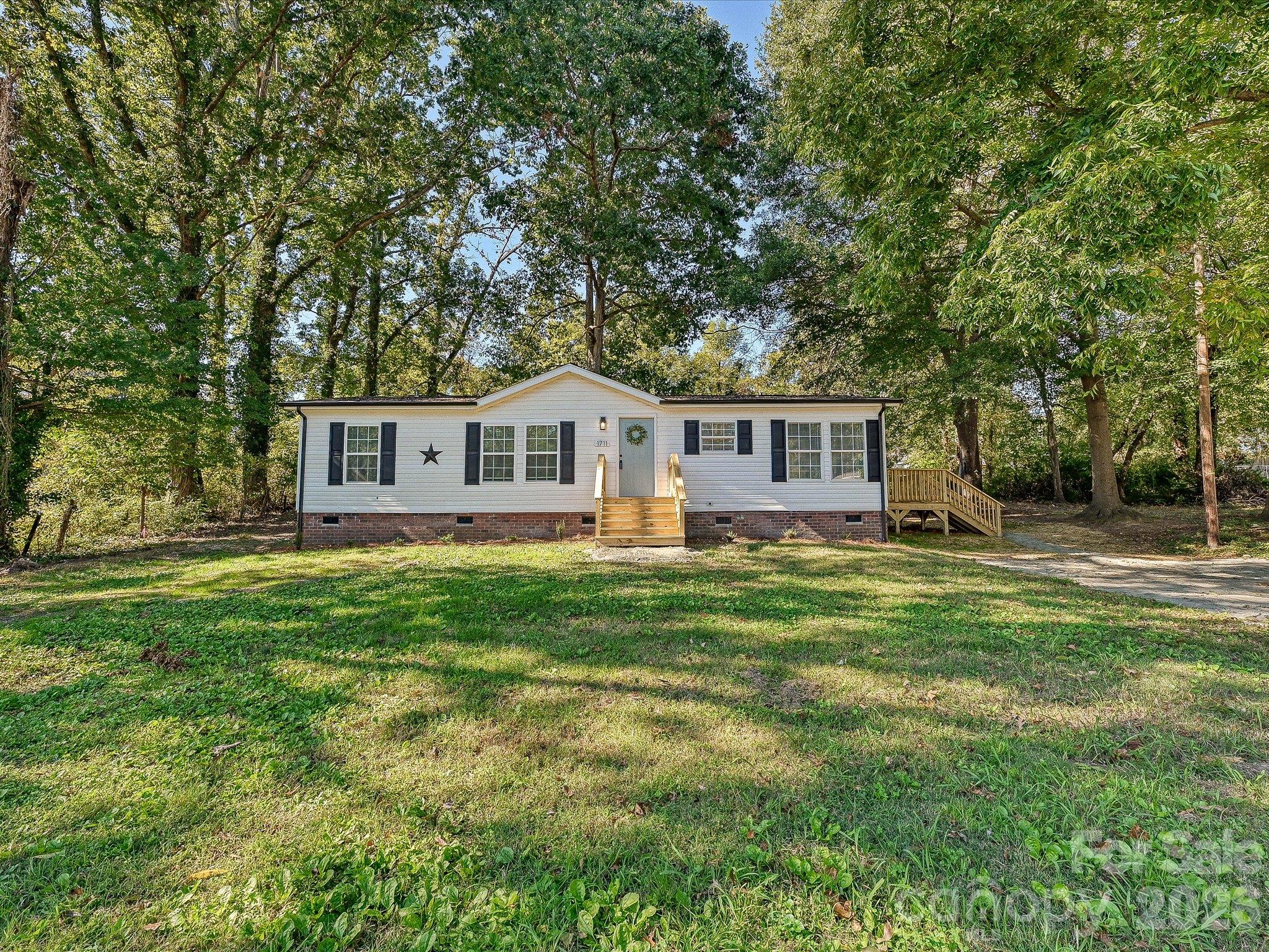 Welcome Home! Come enjoy your newly refreshed home with new architectural roof, new decks, new black gutters and low maintenance vinyl siding and windows! - 1711 Trexlar Avenue, Gastonia