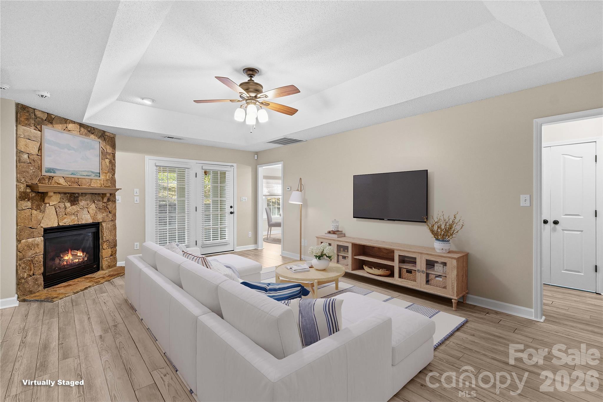 Great Room features Stone Fireplace, Trey Ceiling and Fan - 117 Abbotswood Place, Mooresville